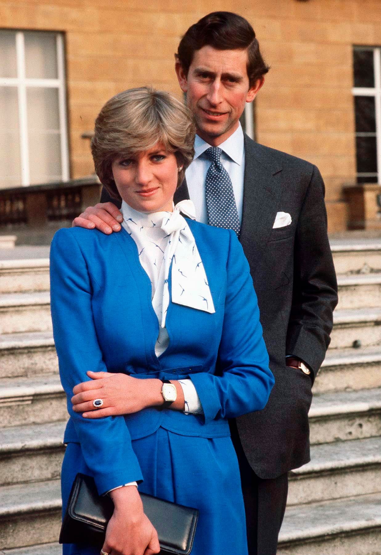 Lady Diana Spencer shows off her sapphire and diamond engagement ring while posing with Prince Charles at Buckingham Palace after the announcement of their engagement | Photo: Getty Images