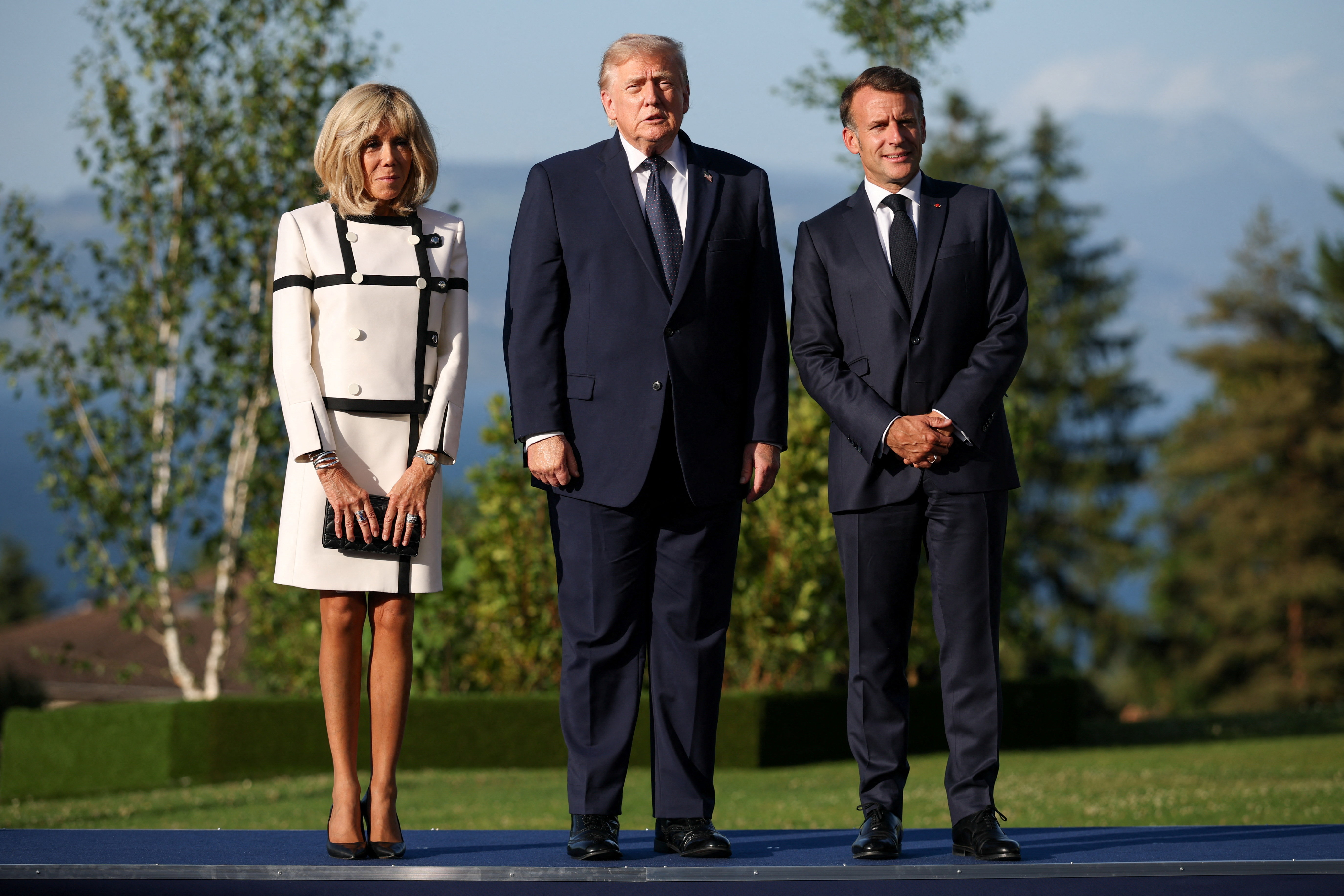 What appeared to be a routine photo-op left viewers studying every detail, from Brigitte Macron's stance to Emmanuel Macron's demeanor nearby. | Source: Getty Images