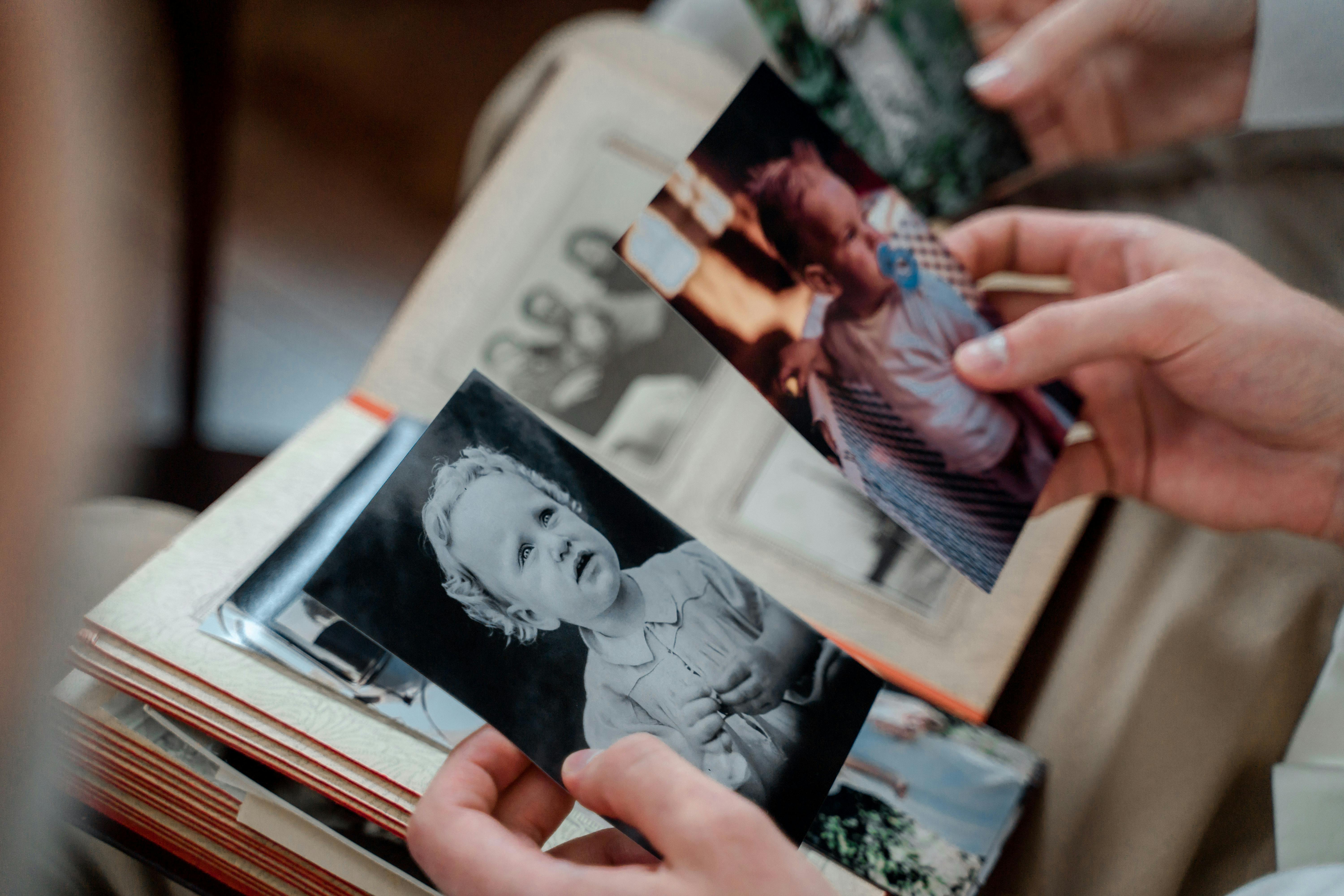 A woman leafing through a photo album | Source: Pexels