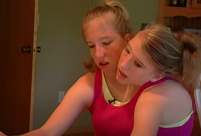 Abby and Brittany Hensel converse with each other, from a video post dated December 2, 2022 | Source: YouTube/Origin