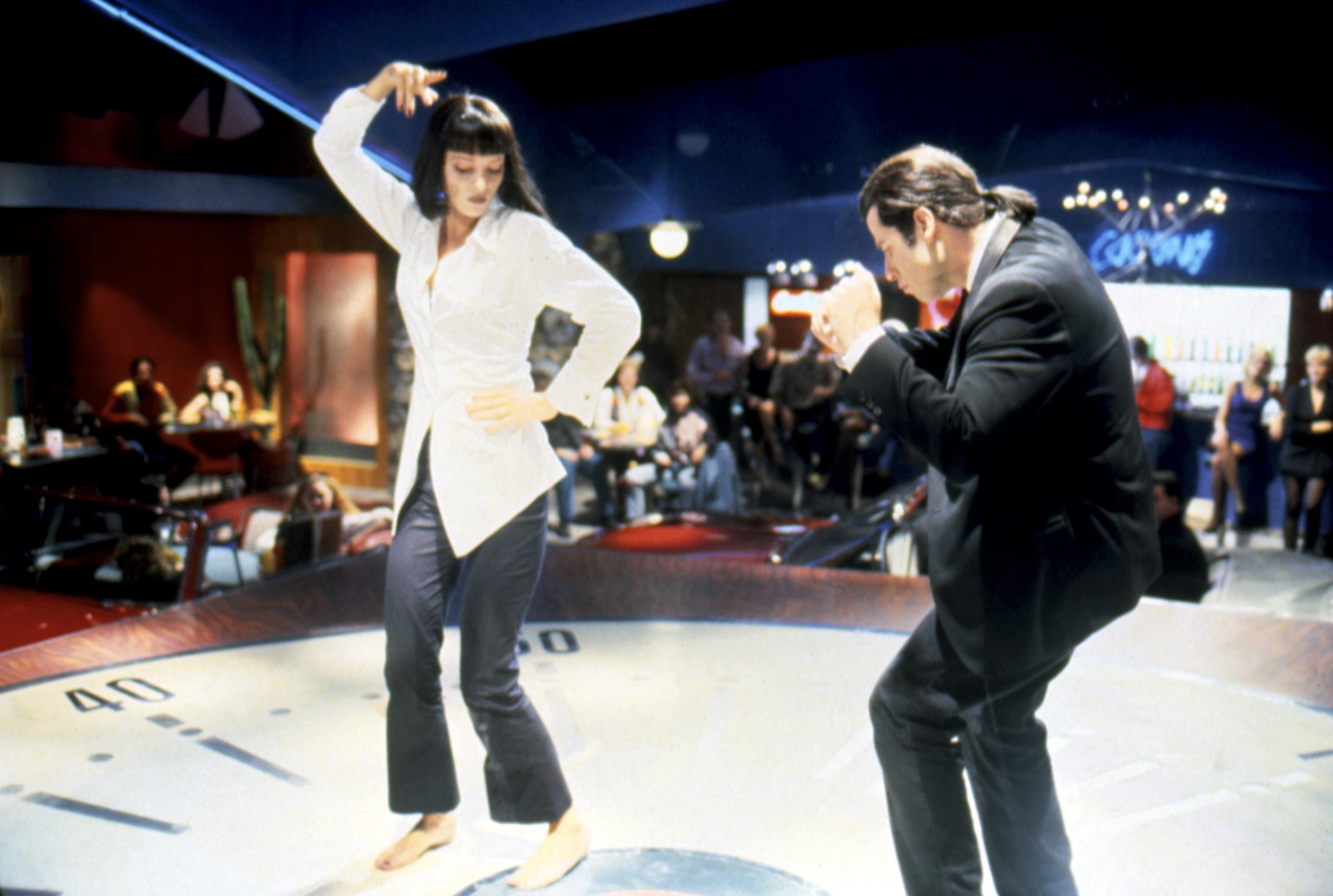 Uma Thurman and John Travolta dancing during a scene in the film "Pulp Fiction"  in 1994 | Source: Getty Images