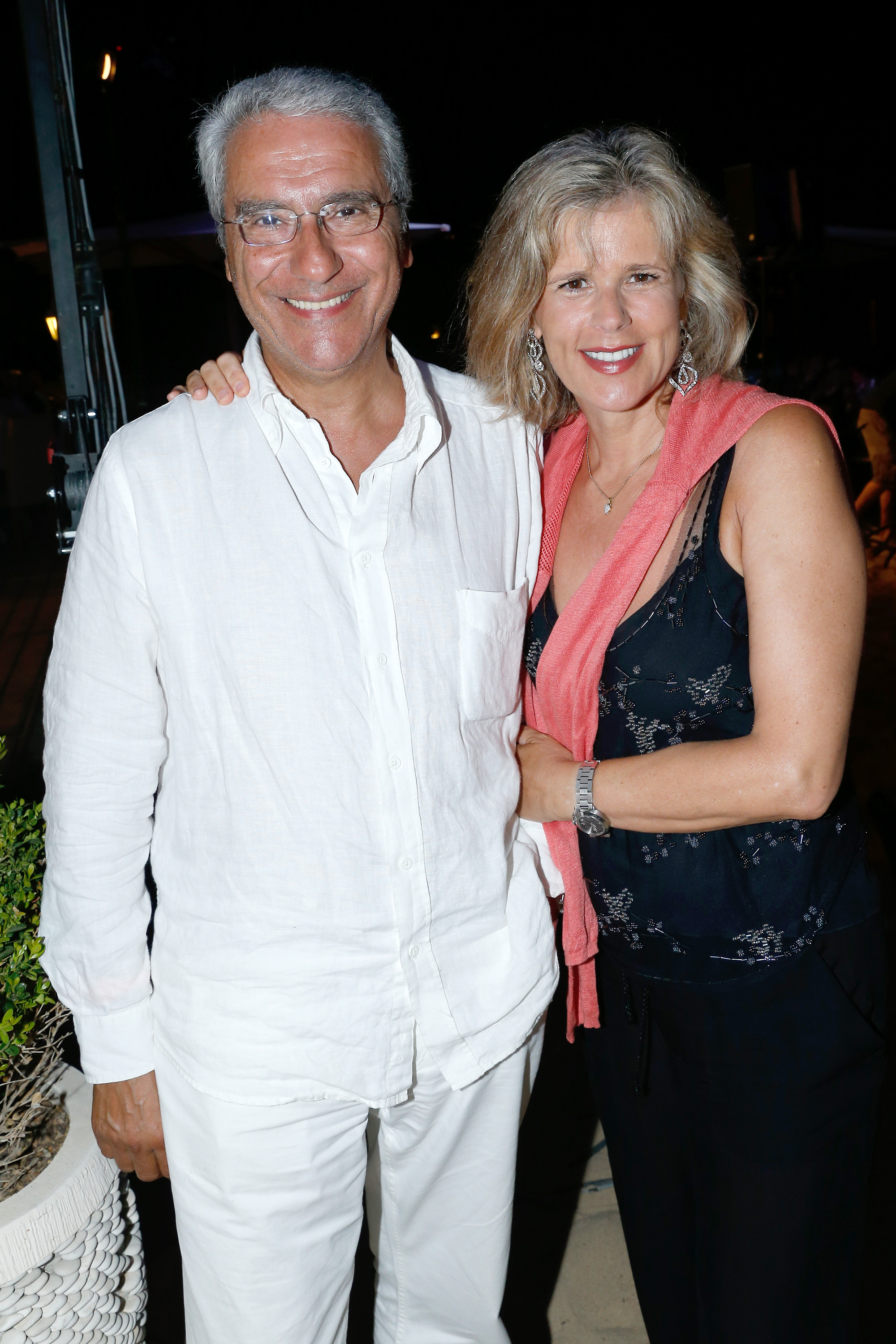 Norbert Balit and his companion Laurence Piquet at President of the Union of Showmen Marcel Campion's party at La Bouillabaisse beach on August 6, 2013 in Saint-Tropez, France | Source: Getty Images