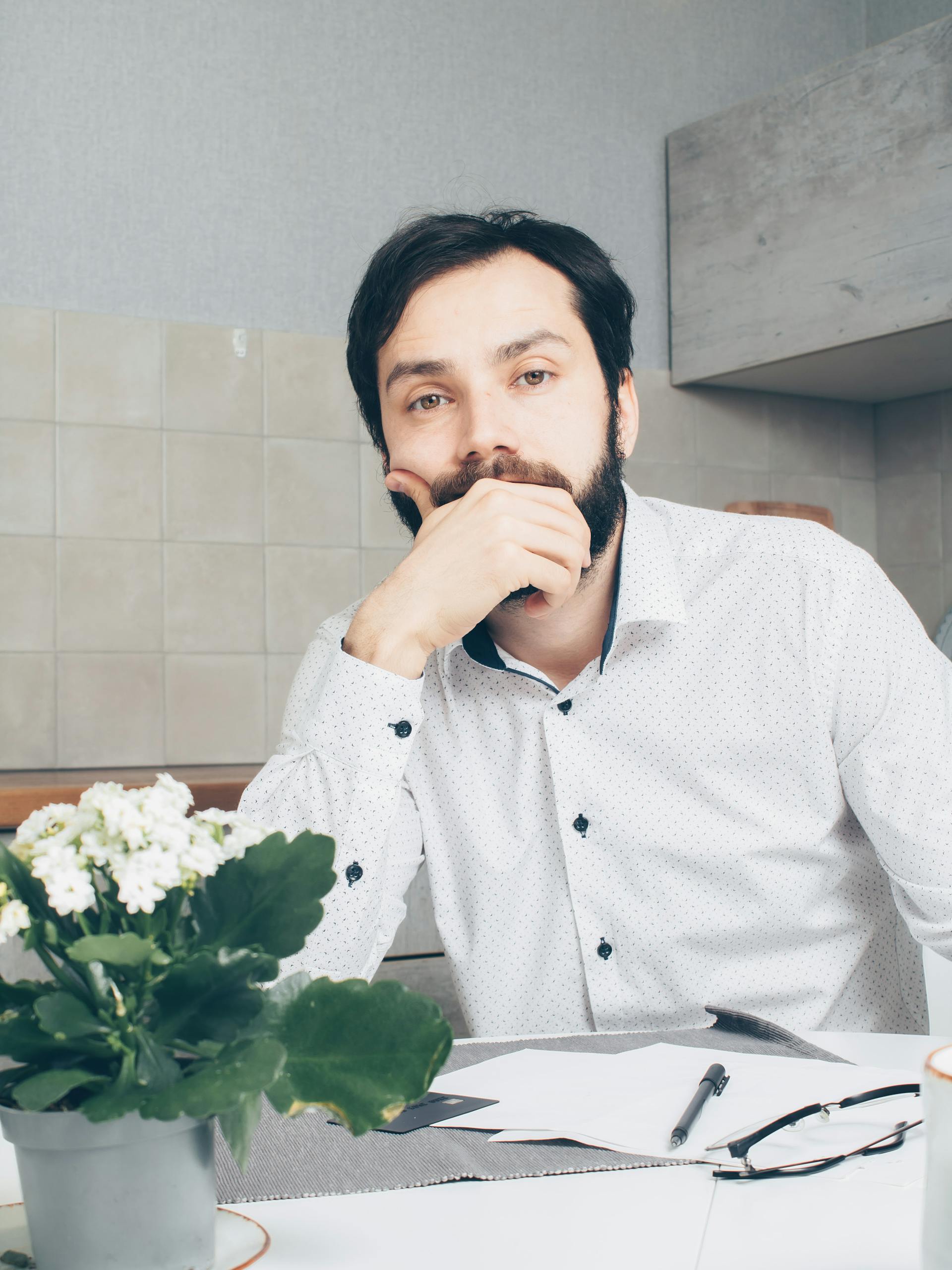 A thoughtful man sitting at the table | Source: Pexels