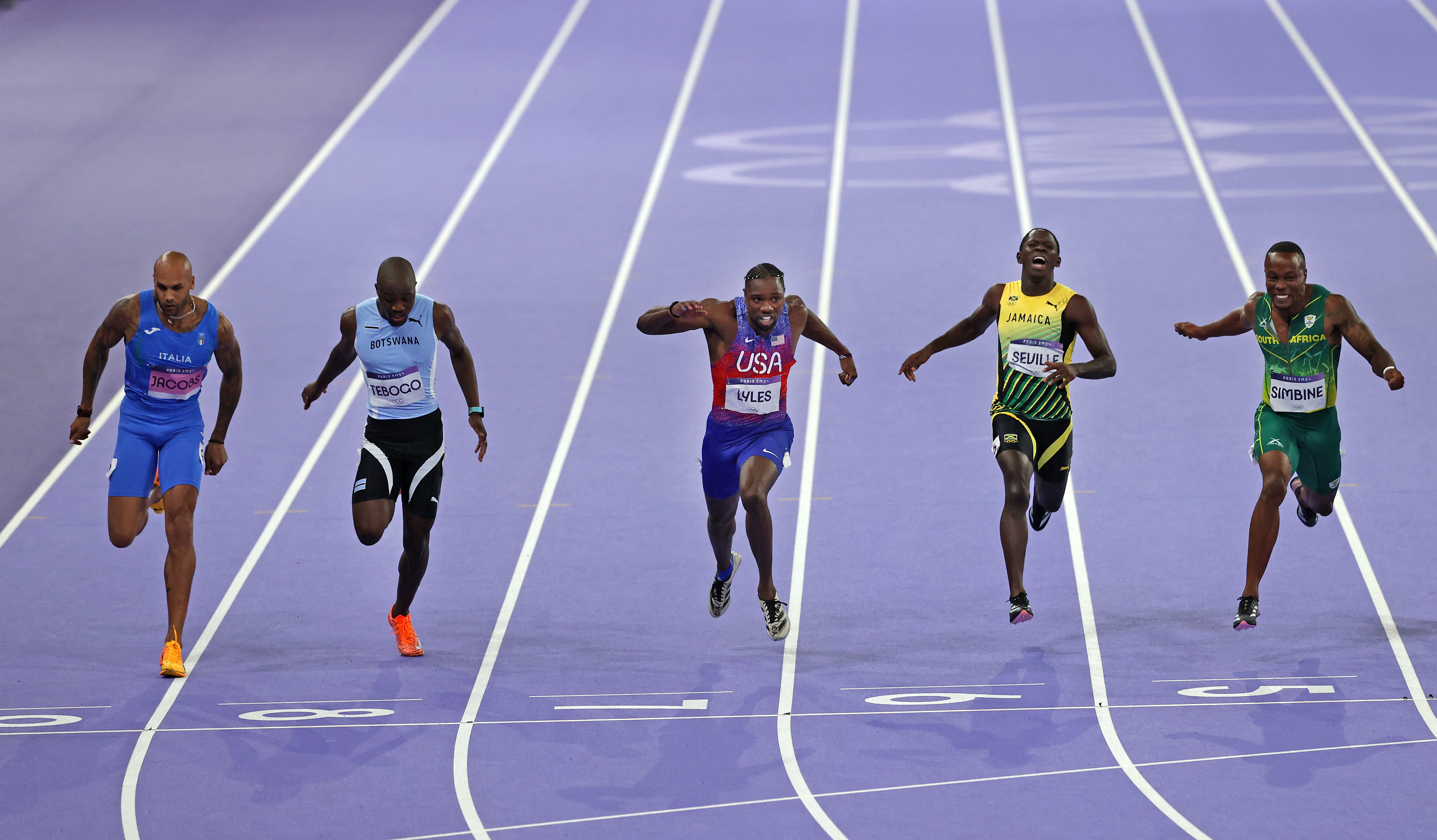 Noah Lyles of Team United States crosses the finish line to win the Men's 100m Final on day nine of the Olympic Games Paris 2024 at Stade de France on August 04, 2024 in Paris, France