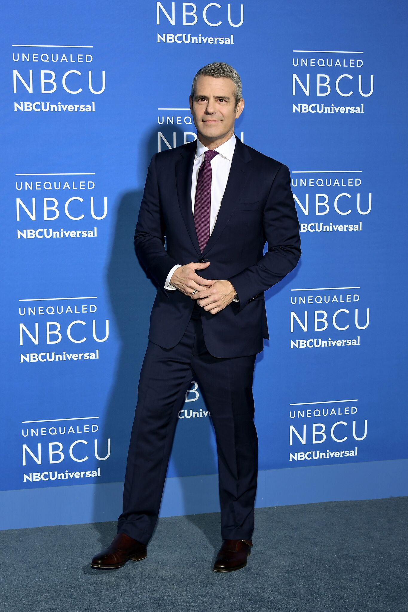 Andy Cohen posing for picture at NBCU event | Getty Images
