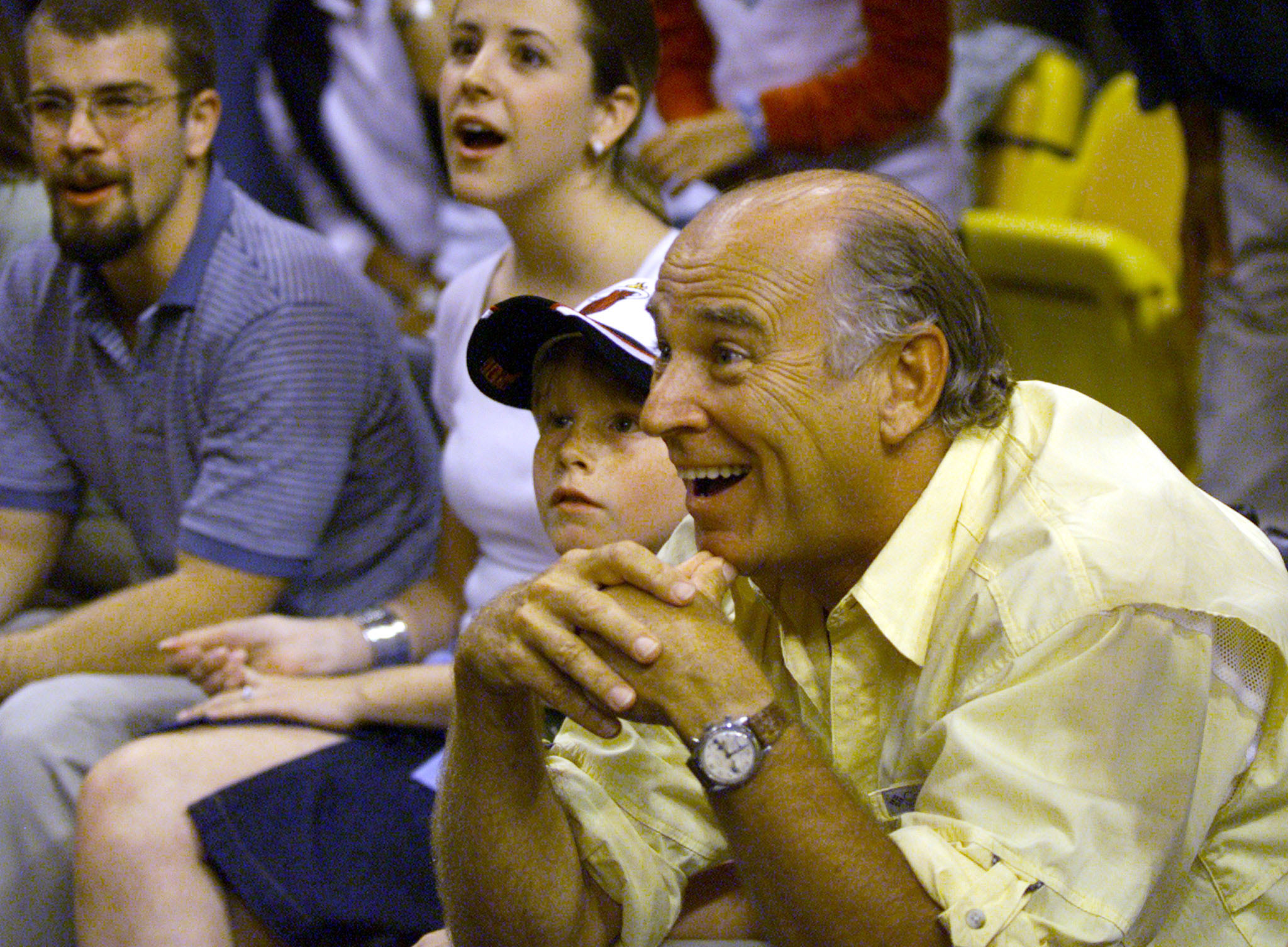 Singer Jimmy Buffet (R) with his six-year-old son Cameron, reacts to being told he's been thrown out from the Miami Heat versus the New York Knicks game February 4, 2001 at the American Airlines arena in Miami. | Source: Getty Images