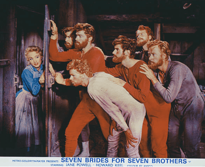 Jane Powell poses with several actors during a movie scene on the poster for "Seven Brides For Seven Brothers," 1954 | Source: Movie Poster Image Art/Getty Images