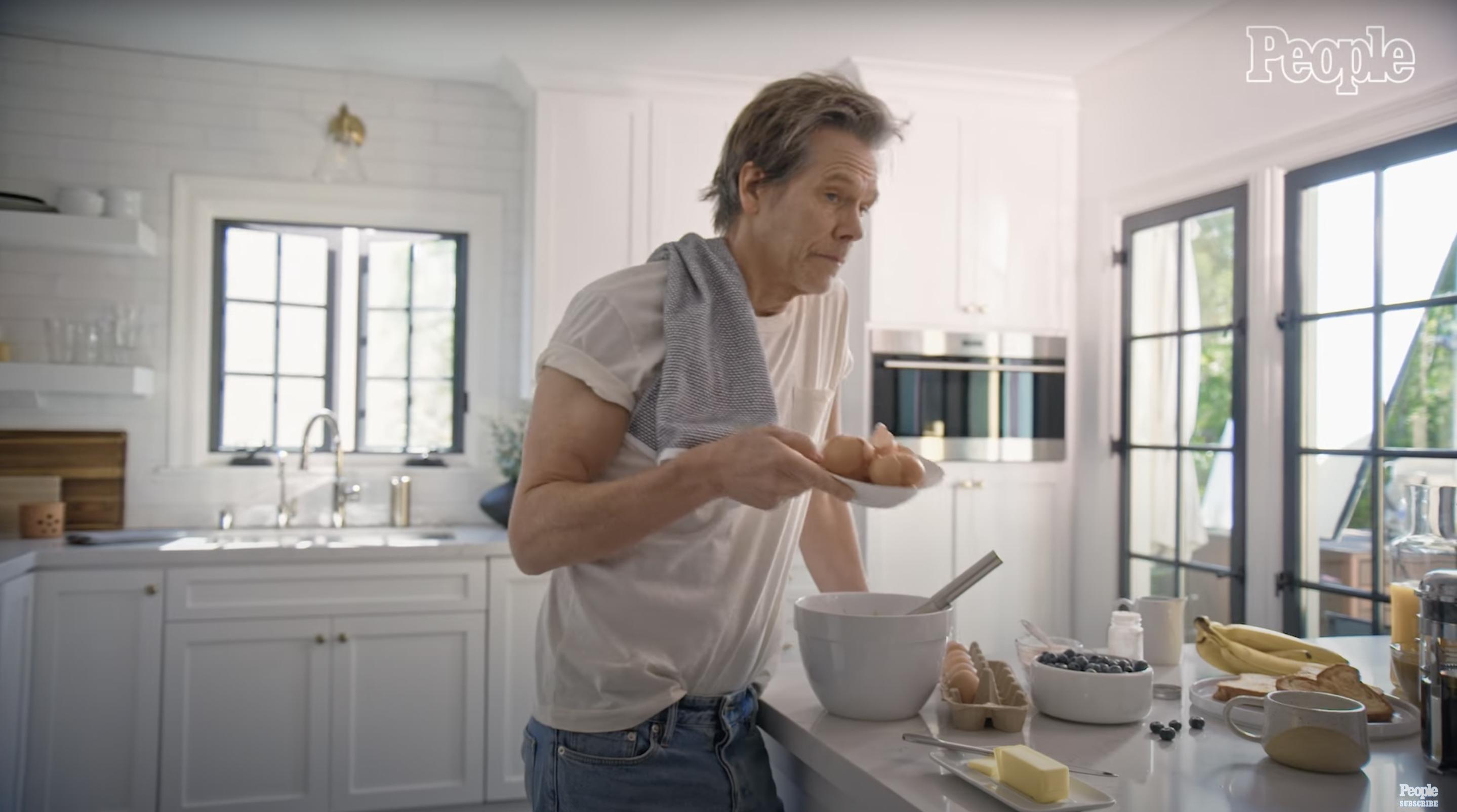 Kevin Bacon preparing a meal in his kitchen | Source: YouTube/@People