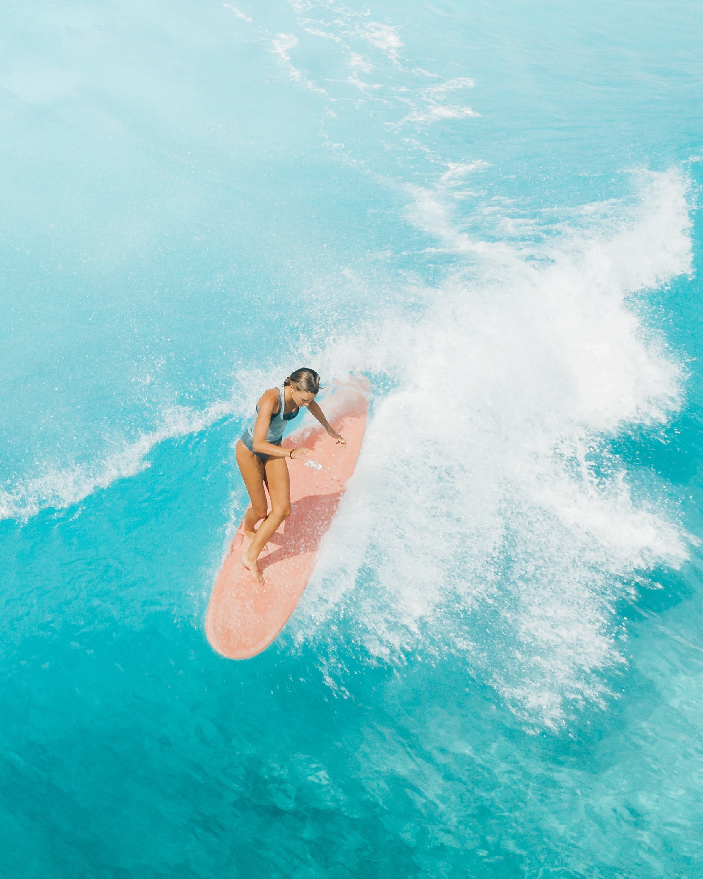 Pictured - An aerial photo of a woman in a bikini surfing | Source: Pexels