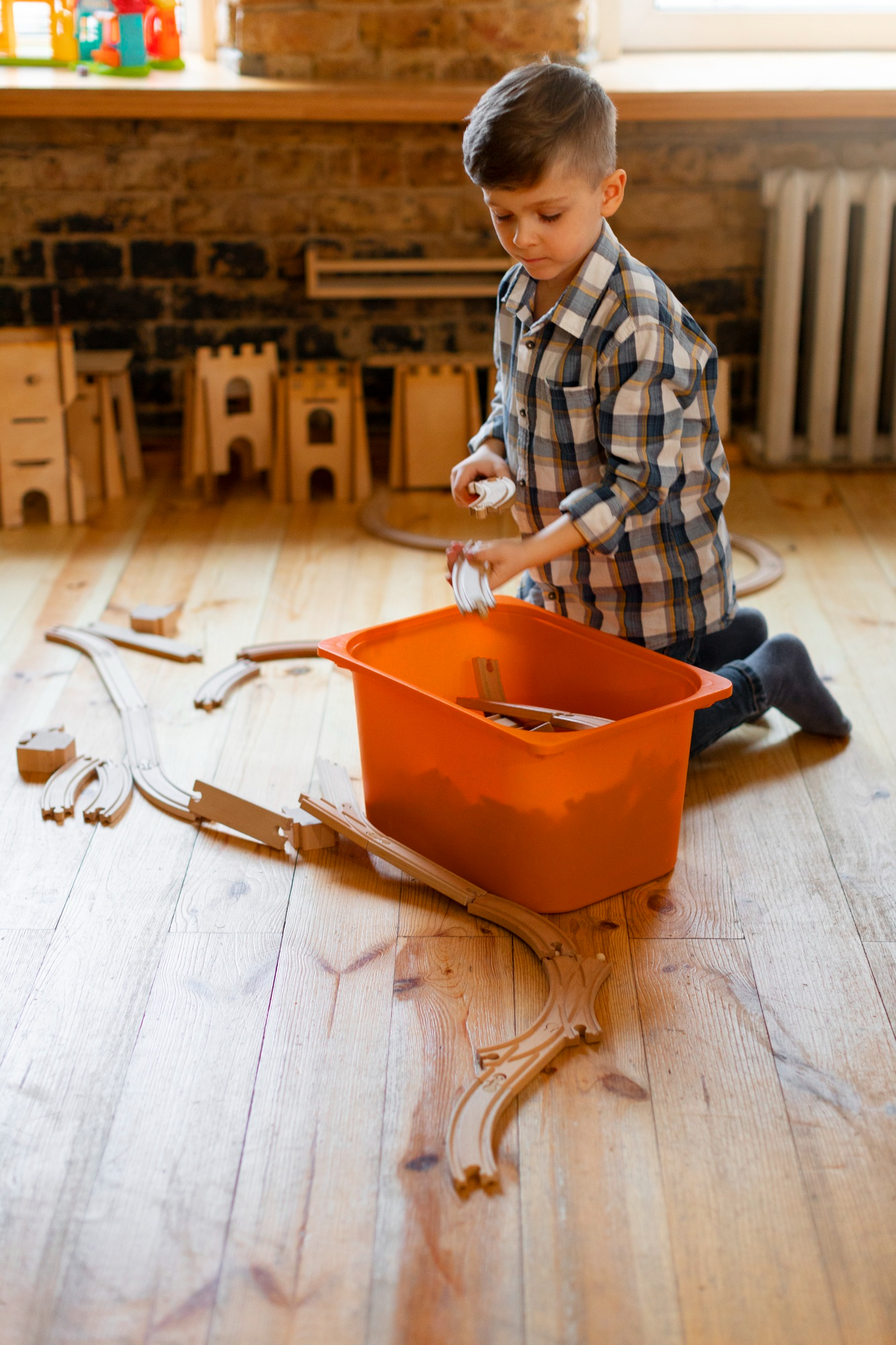 A little boy playing with wooden toys | Source: Freepik