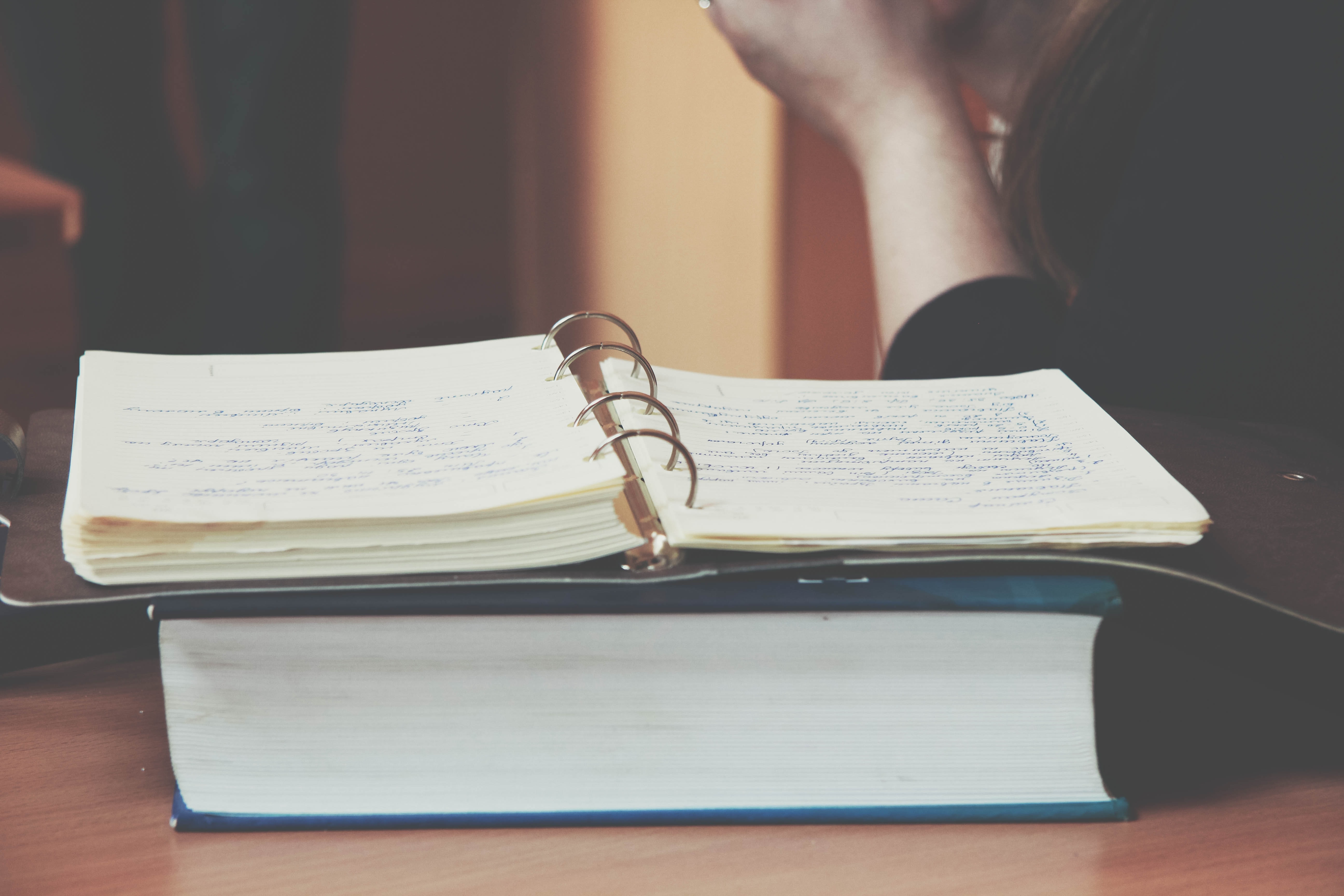 Person in front of an open book | Source: Unsplash / Lubomyr Myronyuk