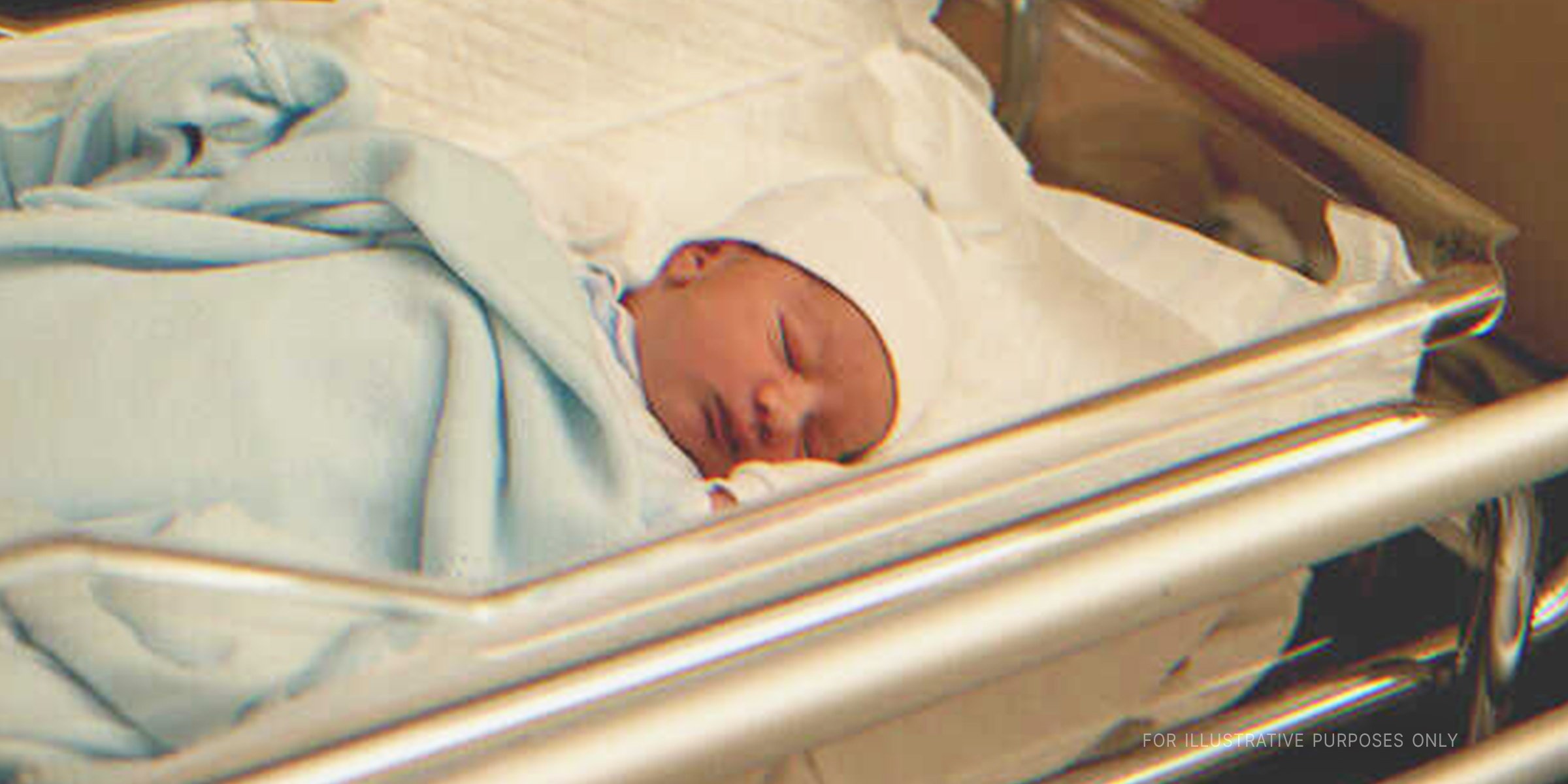 Newborn baby fast asleep in crib | Source: Shutterstock