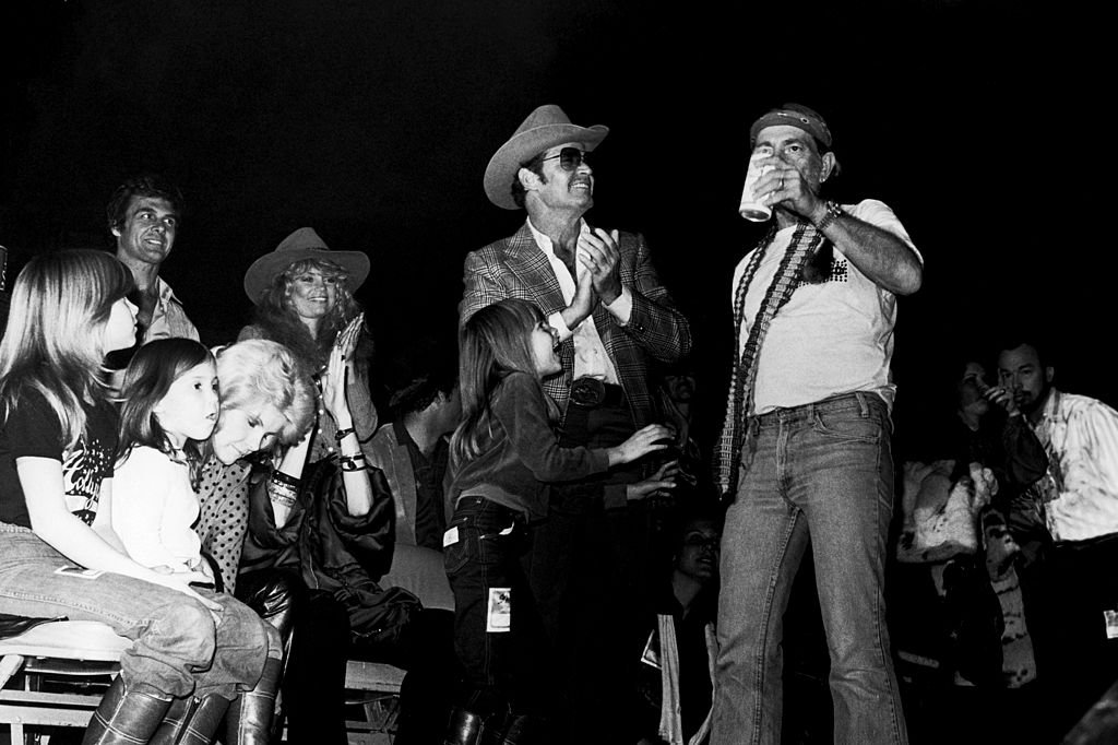 Willie Nelson performs on stage with his and Kris Kristofferson's children, New York, 1980. Image Credit: Getty Images