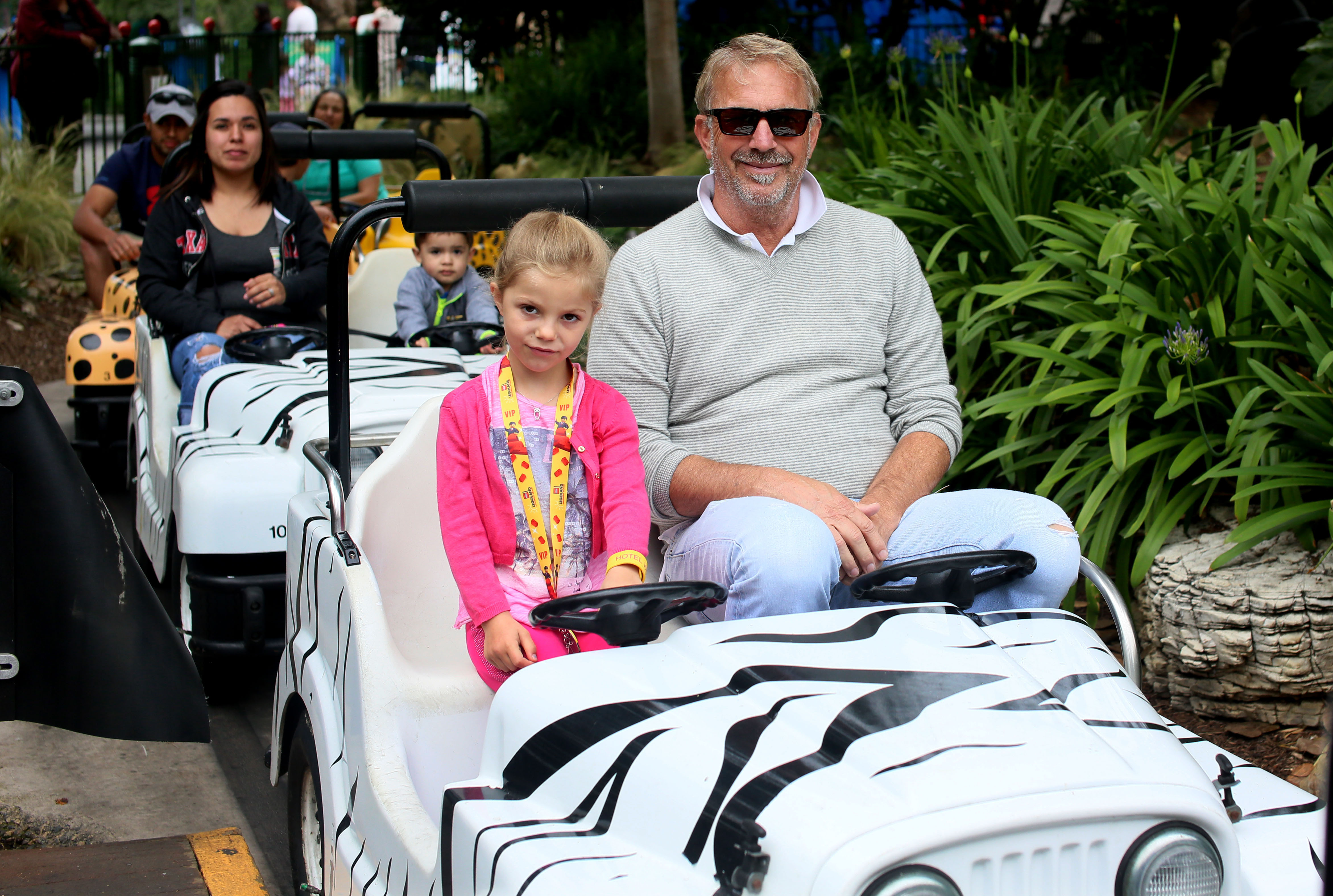 Kevin Costner on a ride with his daughter Grace at Legoland California on May 27, 2015, in Calsbad | Source: Getty Images