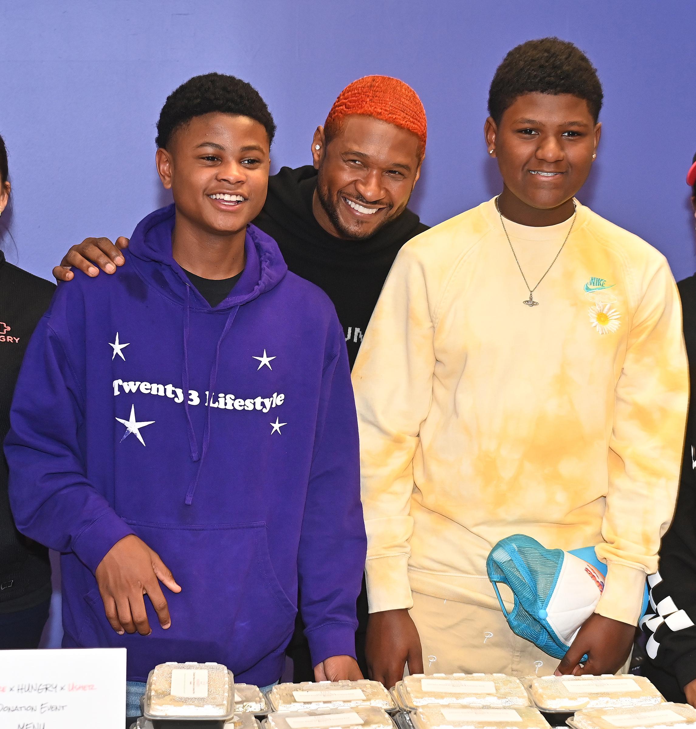 Usher Raymond attends a Healthy Thanksgiving meals giveaway with his sons Usher “Cinco” and Naviyd on November 23, 2022, in Sandy Springs, Georgia. | Source: Getty Images