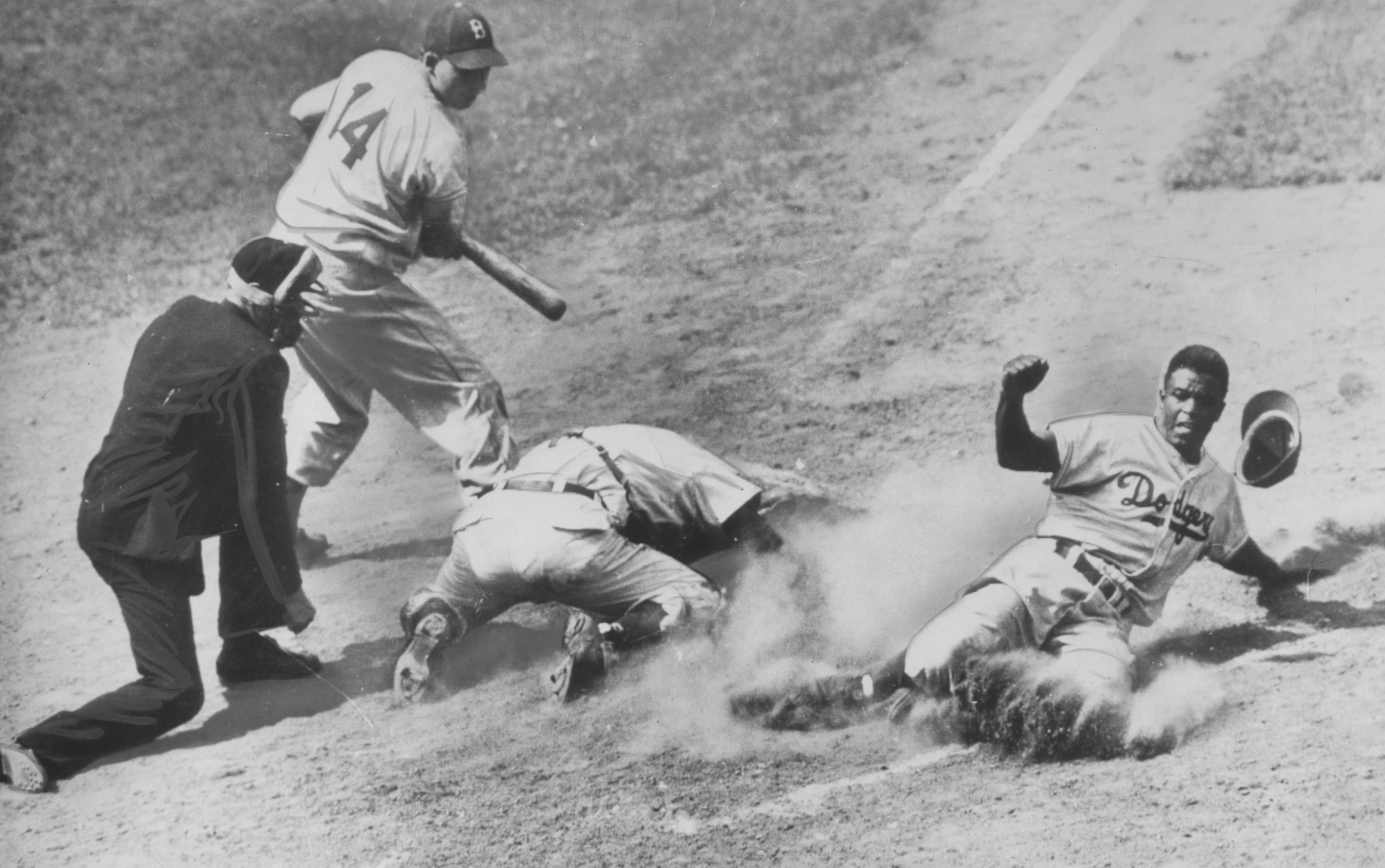  Jackie Robinson sliding into home plate during a baseball game in 1948 | Source: Getty Images