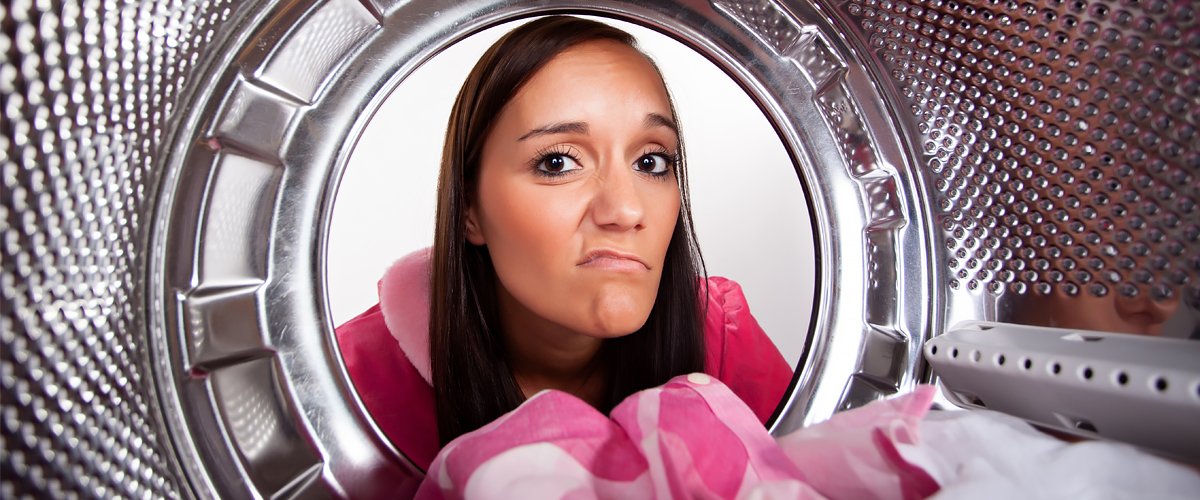 Une femme et sa machine à laver. | Photo : Shutterstock
