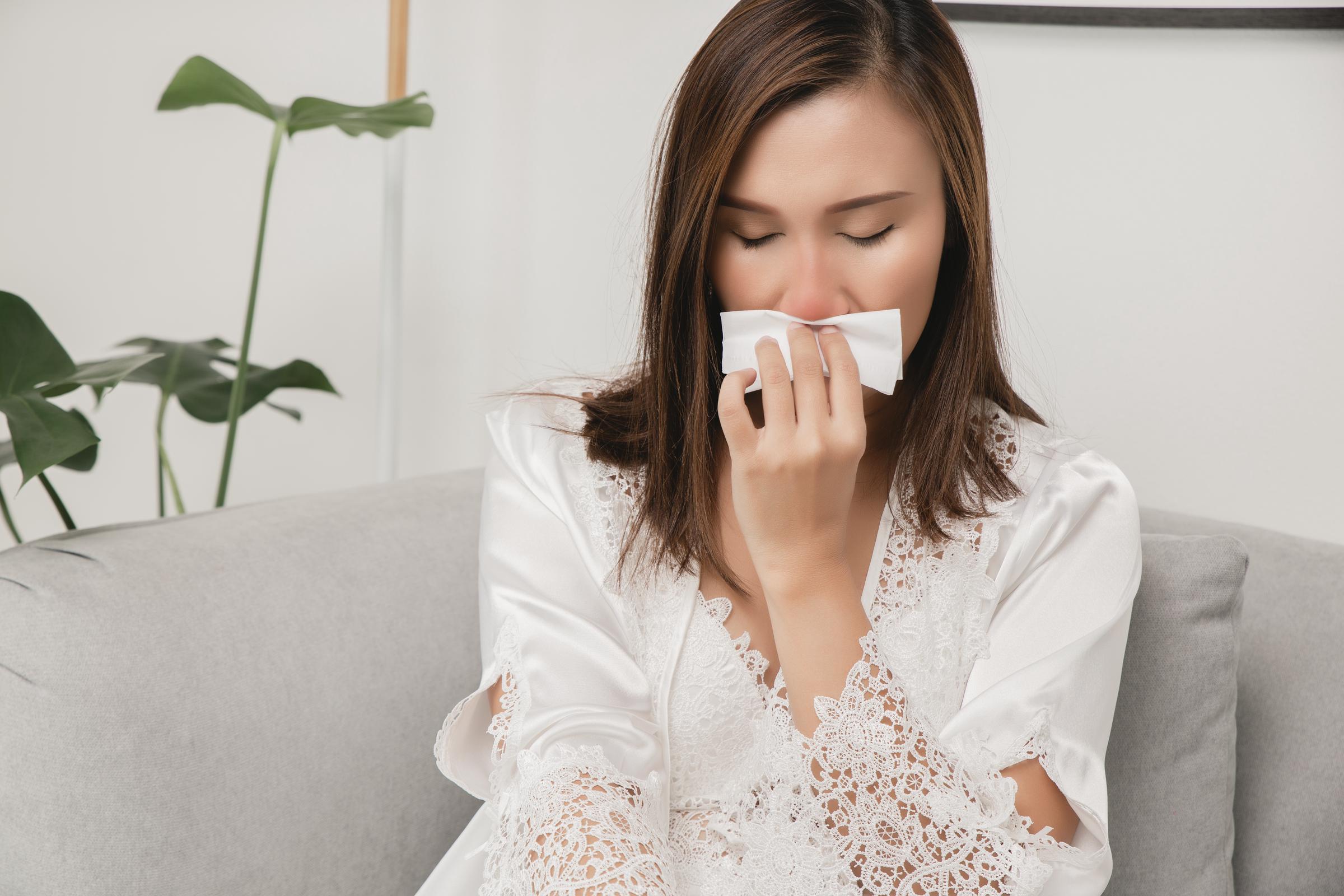 A young woman suffering from a nosebleed | Source: Getty Images