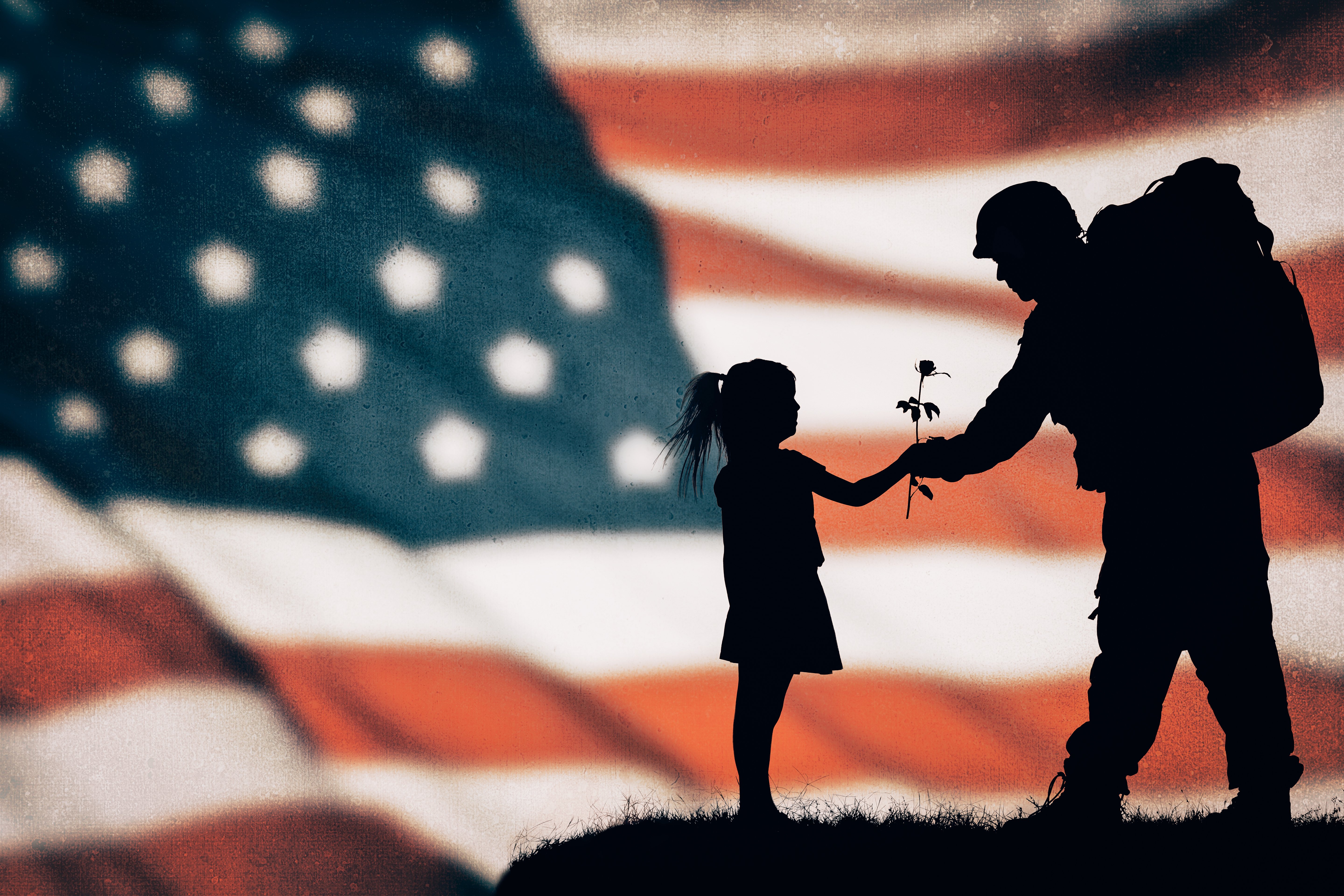 A little girl giving a rose to an American soldier | Photo: Shutterstock