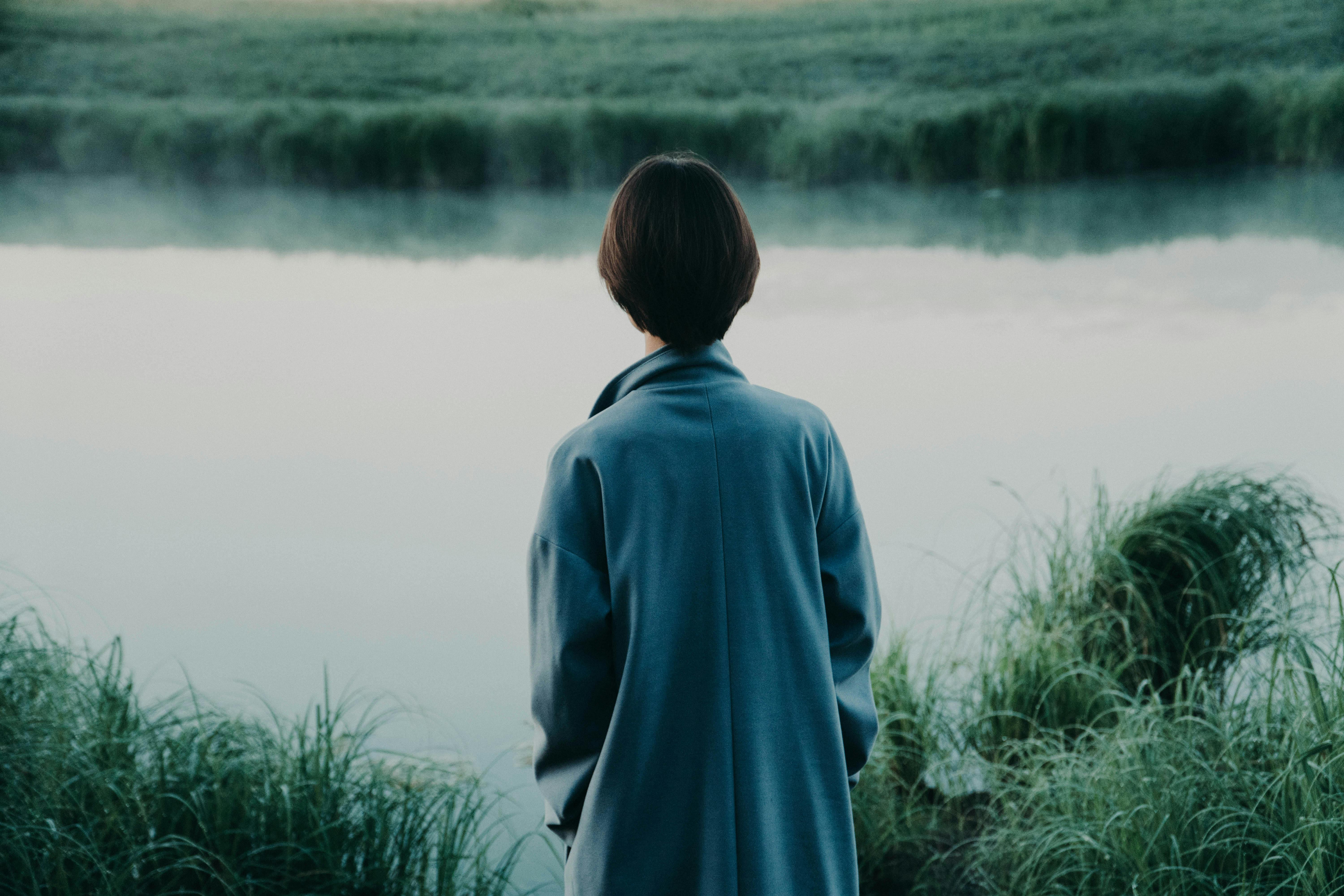 A person standing near pond | Source: Pexels