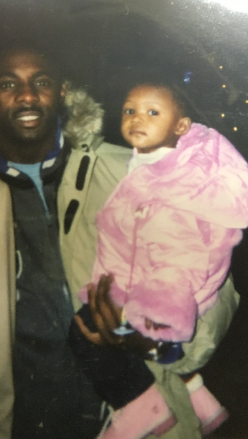 Idris Elba cradles a toddler-aged Isan Elba in his arms during what appears to be a nighttime outing. | Source: Instagram/isanelba
