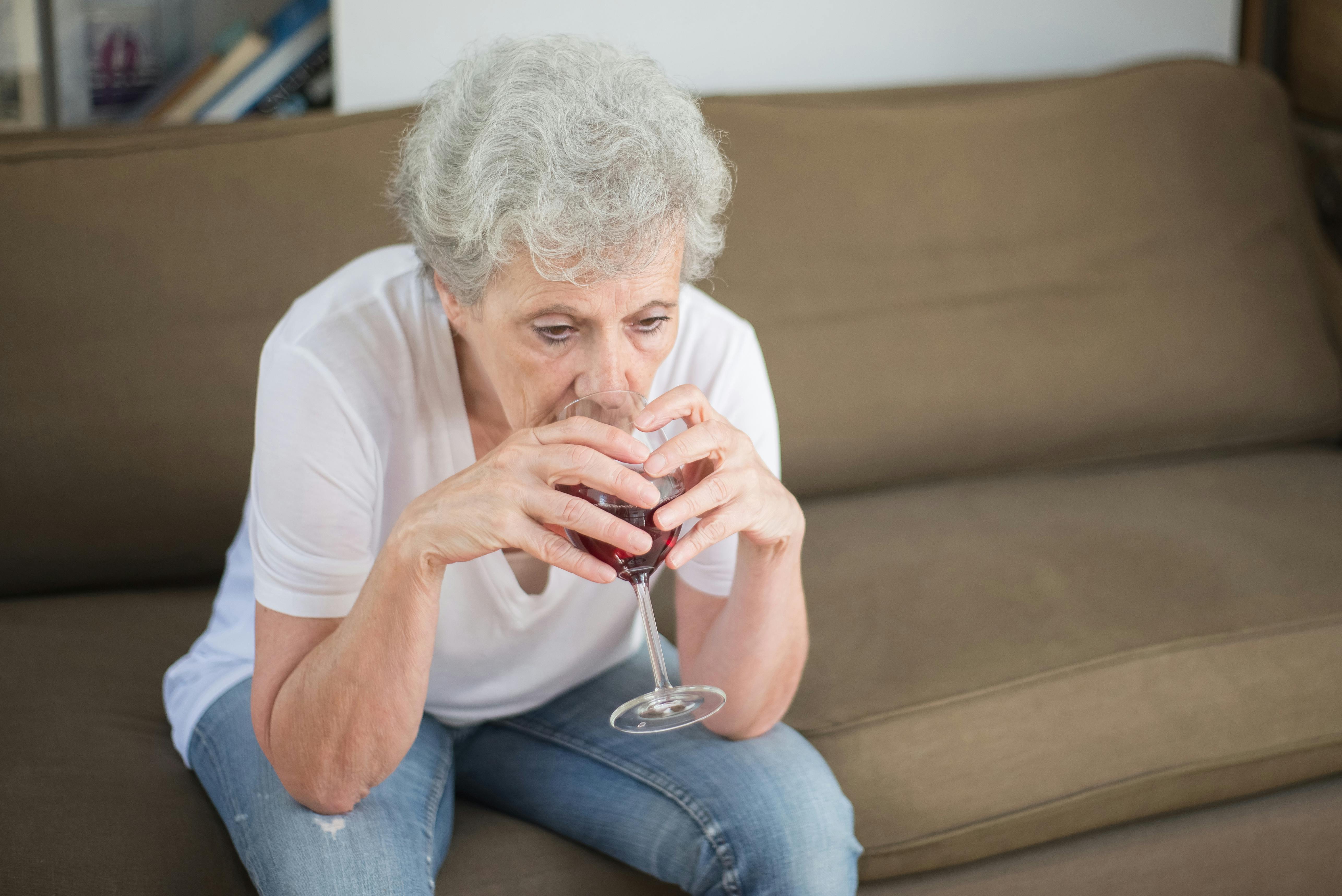A sad woman drinking wine alone | Source: Pexels