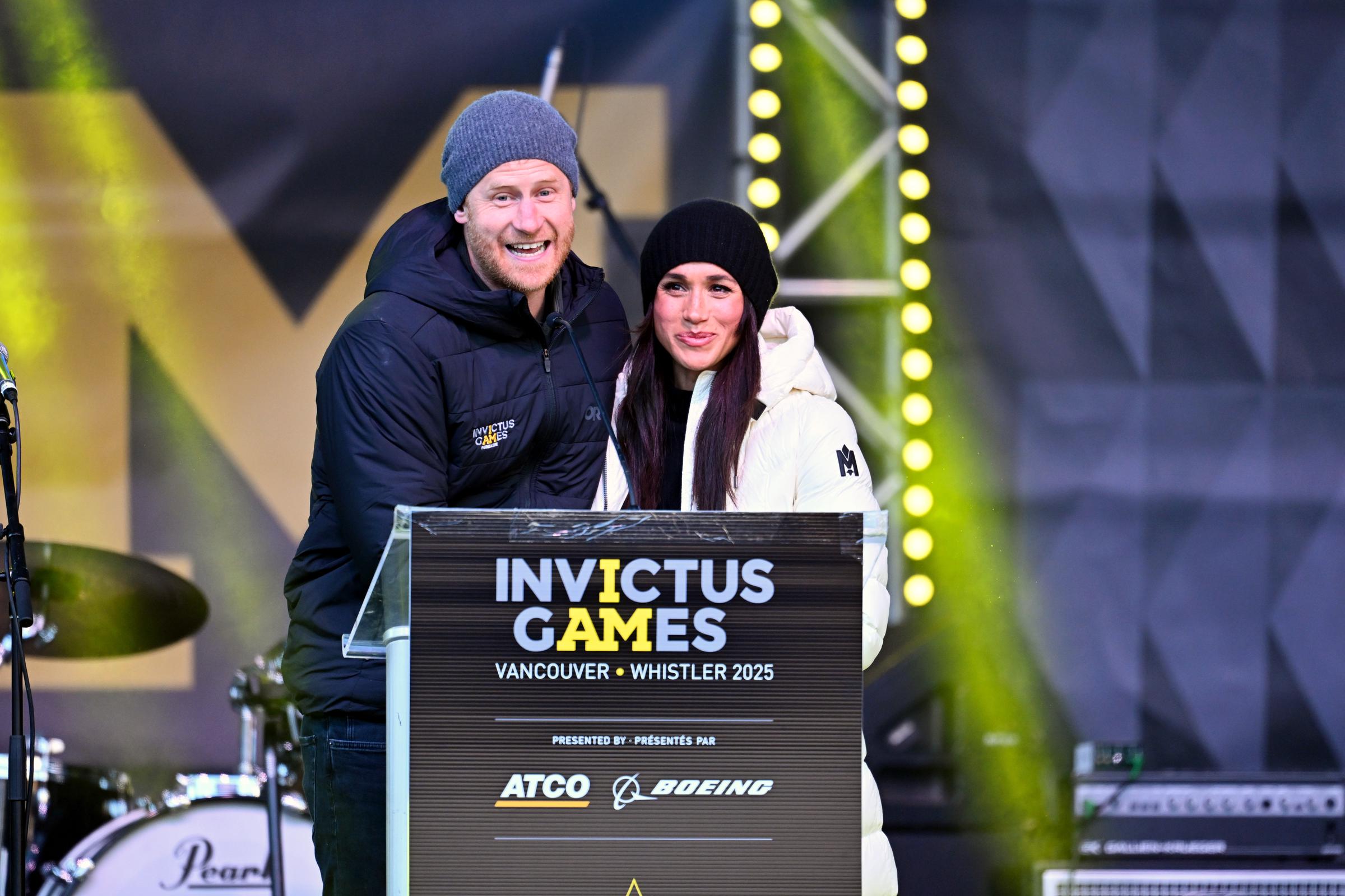 Prince Harry speaking on stage at the event alongside Meghan Markle. | Source: Getty Images