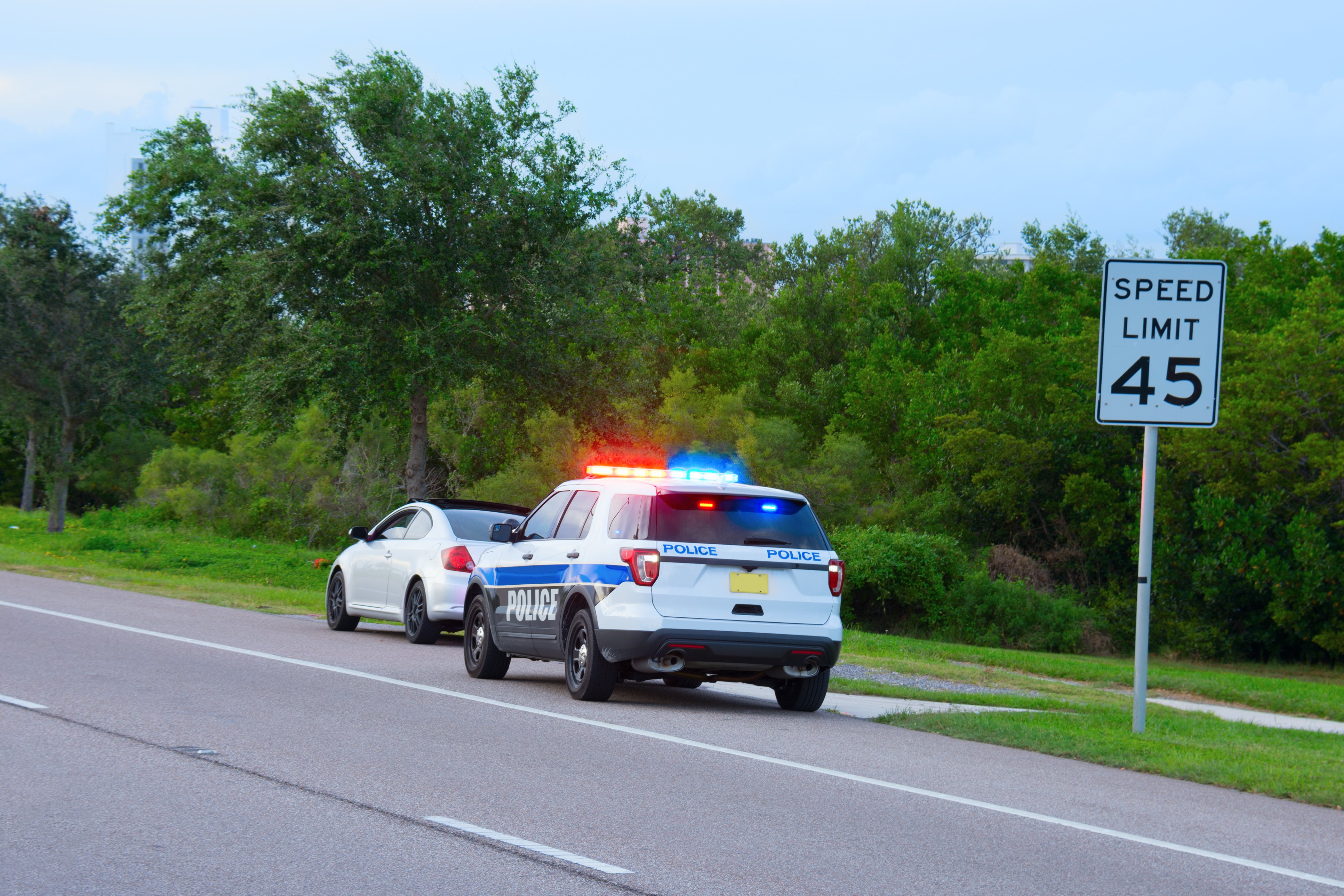 A police vehicle appears to be pulling a car over. | Photo; Shutterstock