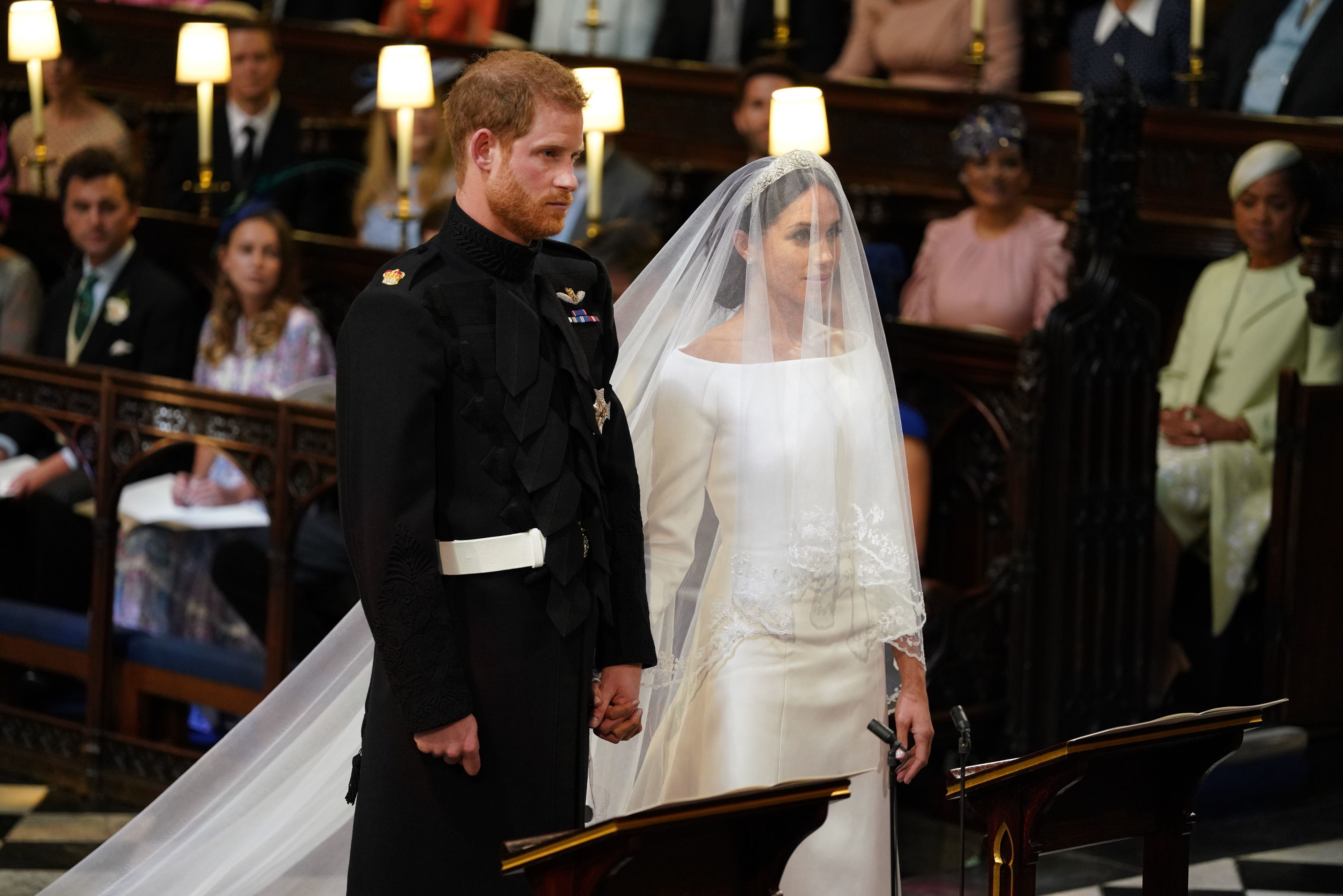 Britain's Prince Harry, Duke of Sussex and Meghan Markle stand together for their wedding in St George's Chapel, Windsor Castle, in Windsor, on May 19, 2018. | Source: Getty Images