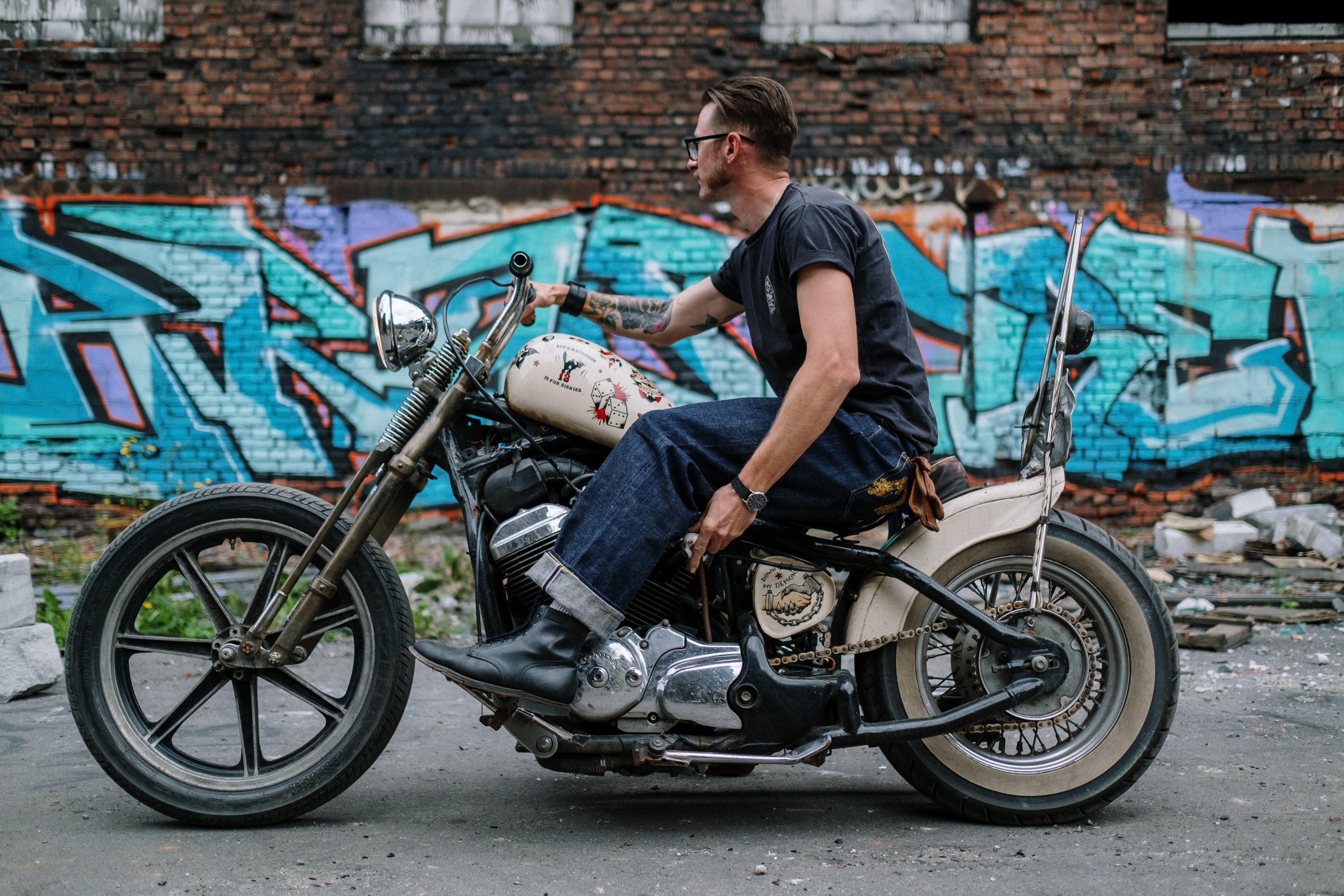 A man in a black t-shirt riding a motorbike. | Pexels/ cottonbro