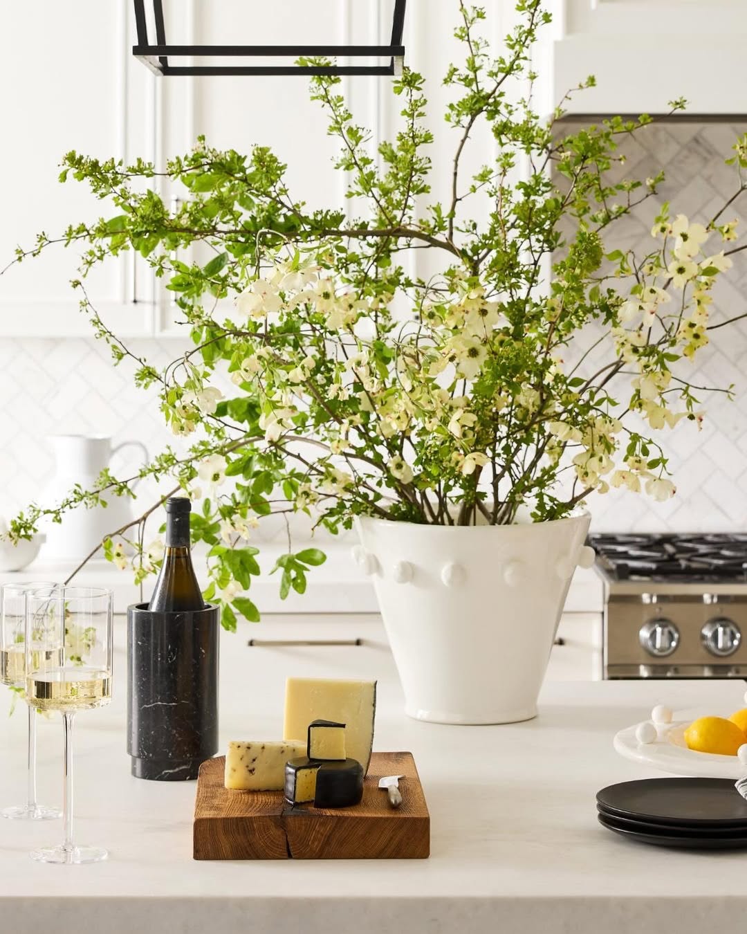 Cheese board and floral arrangement pictured on the kitchen island inside Diane Keaton’s Sullivan Canyon home, dated August 15, 2024 | Source: Instagram/hudsongracesf