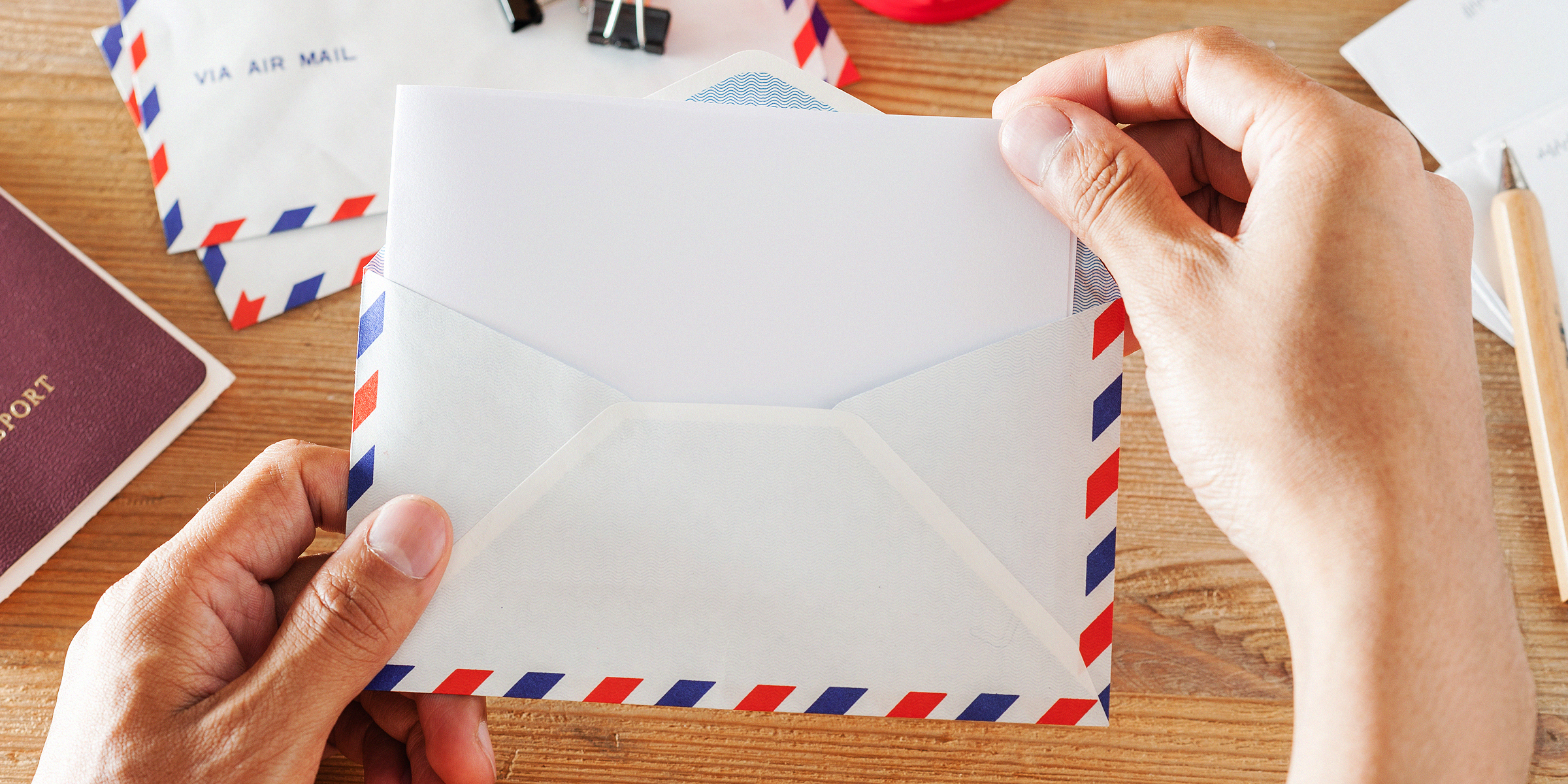 Person holding an envelope | Source: Shutterstock