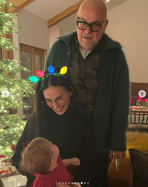 Demi Moore and florist Eric Buterbaugh smiled as they looked at Louetta Isley Willis Thomas near the Christmas tree in a photo shared in April 2024. | Source: Instagram/rumerwillis