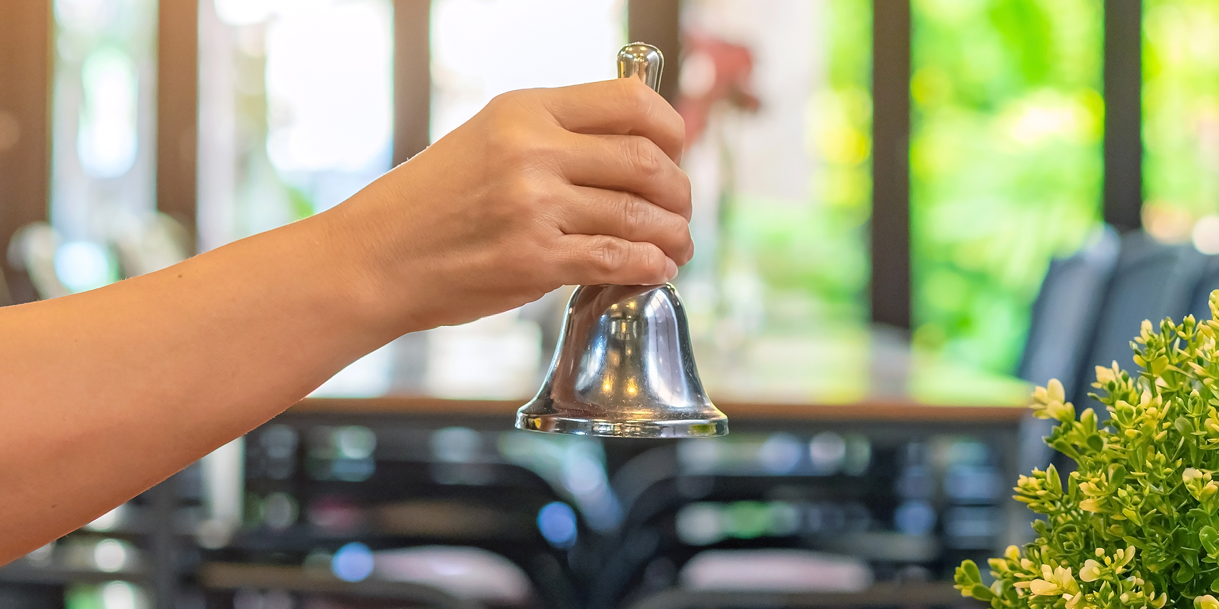 Woman ringing a restaurant service bell | Source: Shutterstock