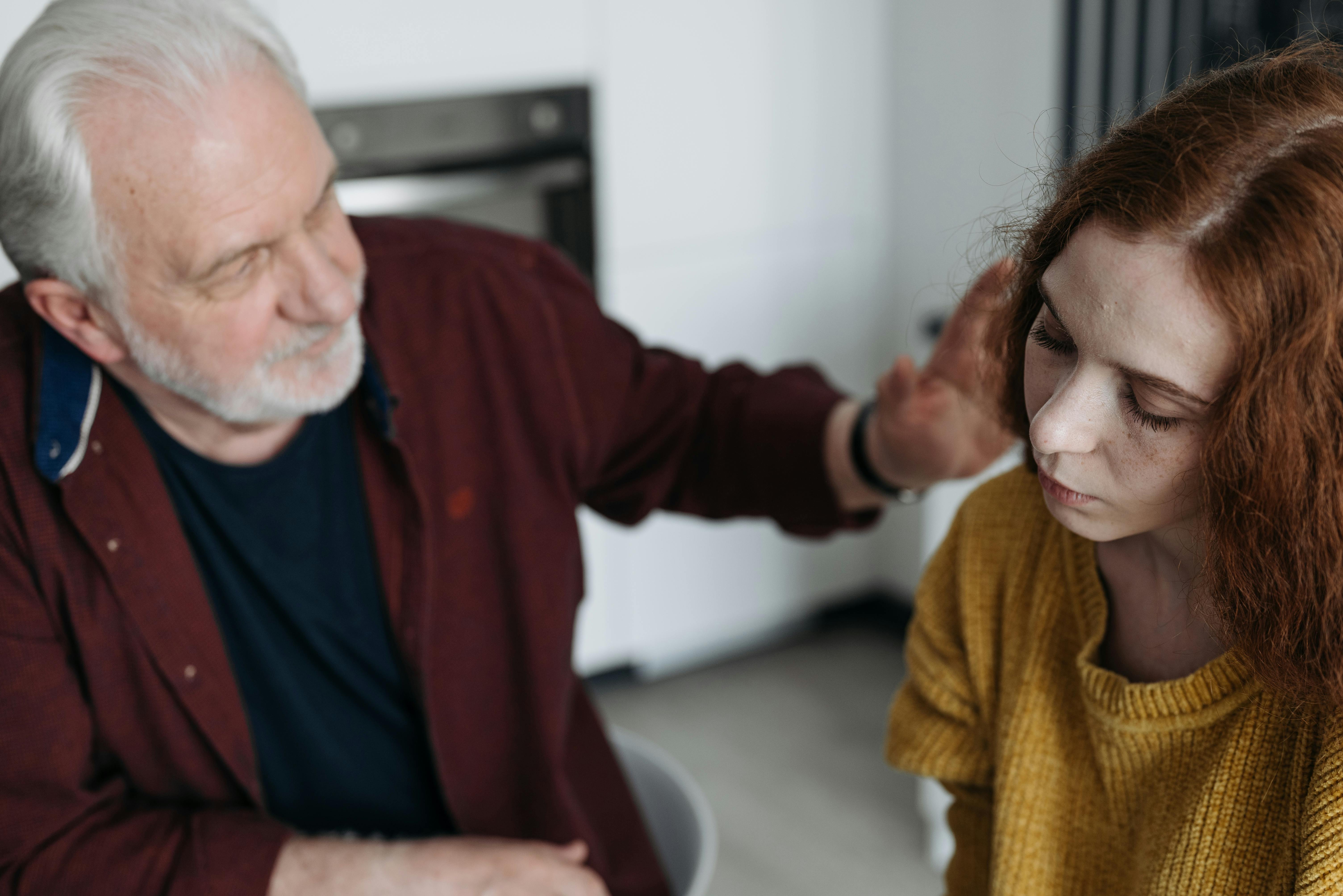 An elderly man with a young woman | Source: Pexels