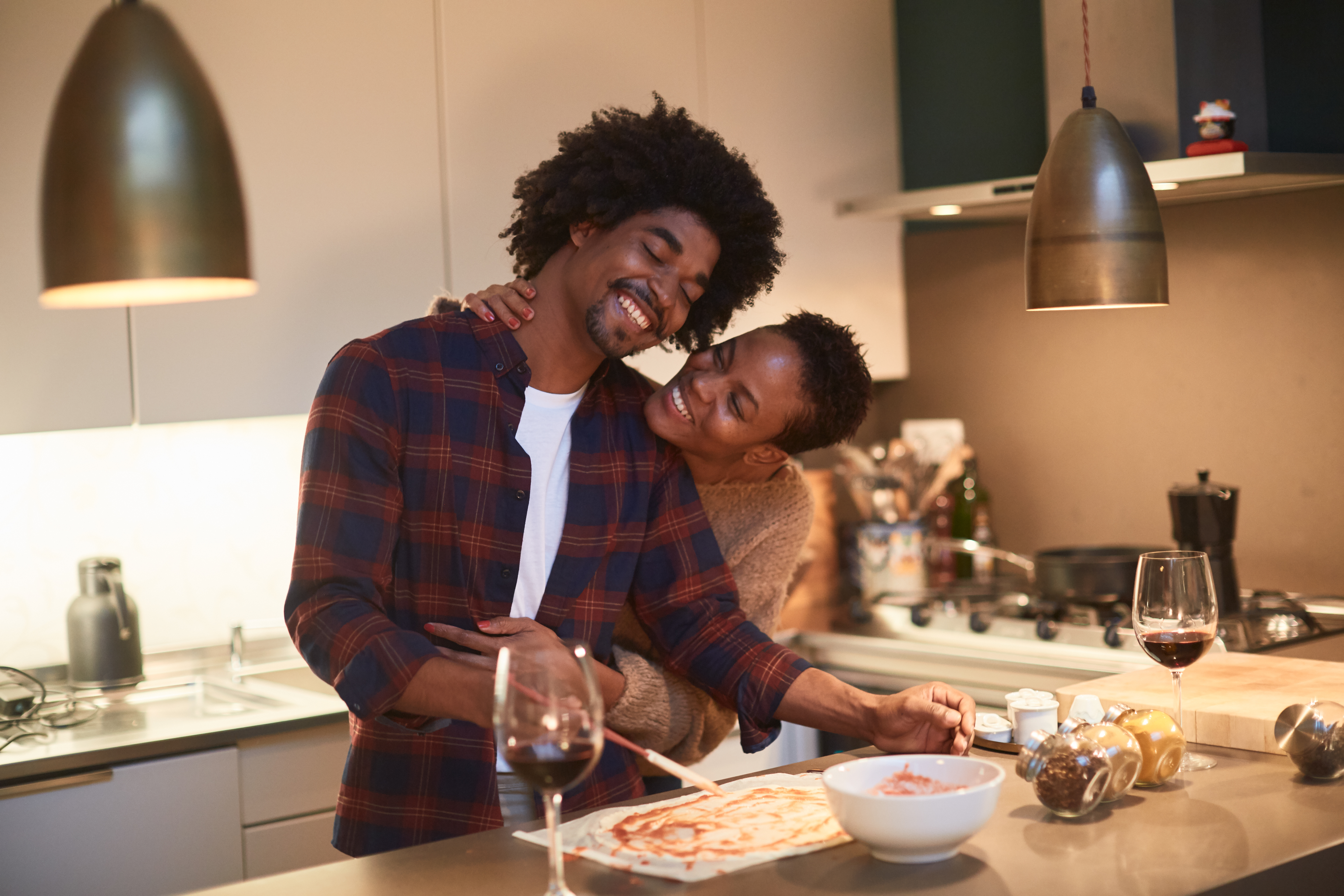 Young couple cooking at home and celebrating Saint Valentine | Source: Getty Images