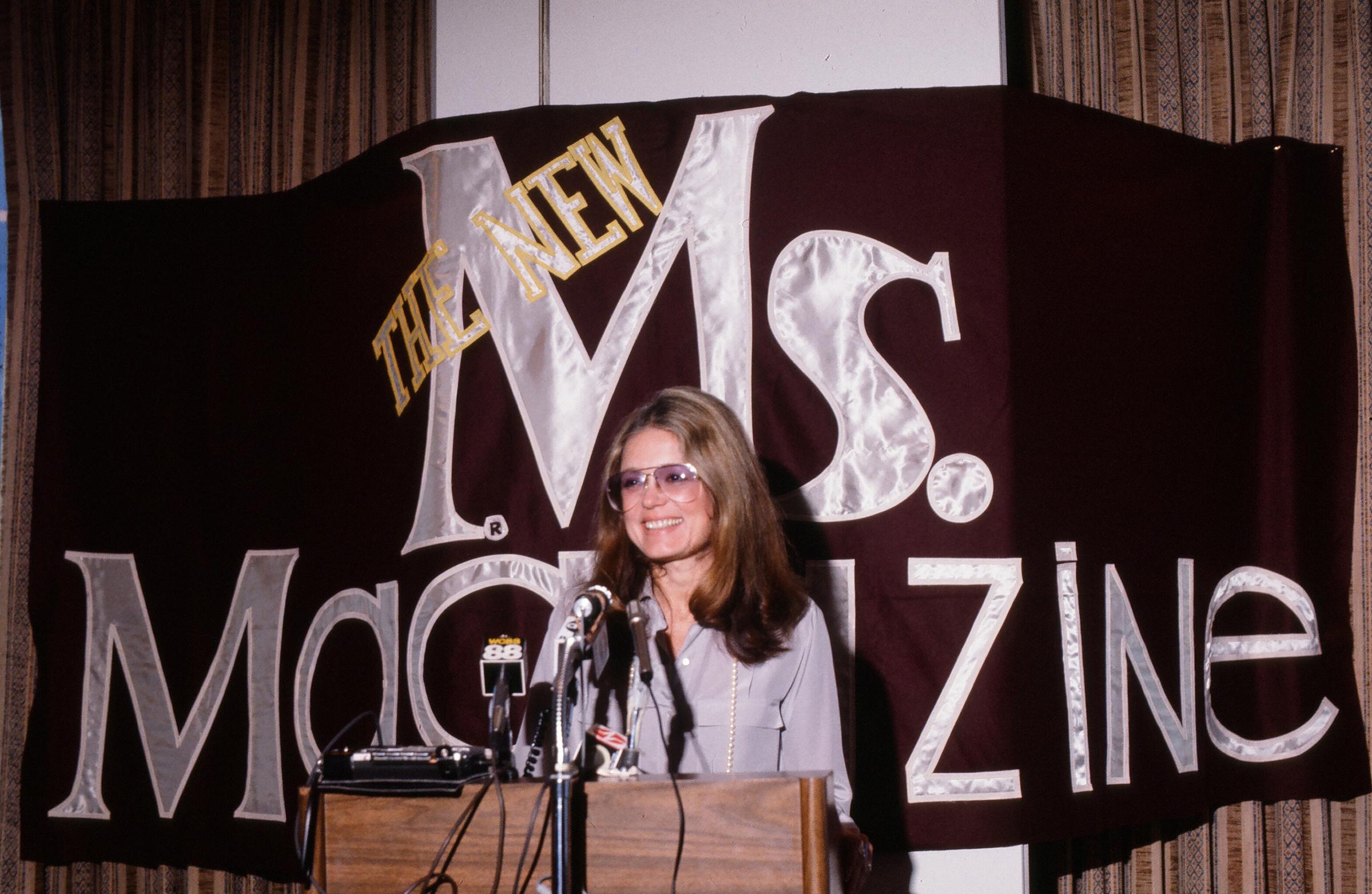Gloria Steinem speaks from a podium at a press conference about Ms. Magazine, which she co-founded, 1980s | Source: Getty Images