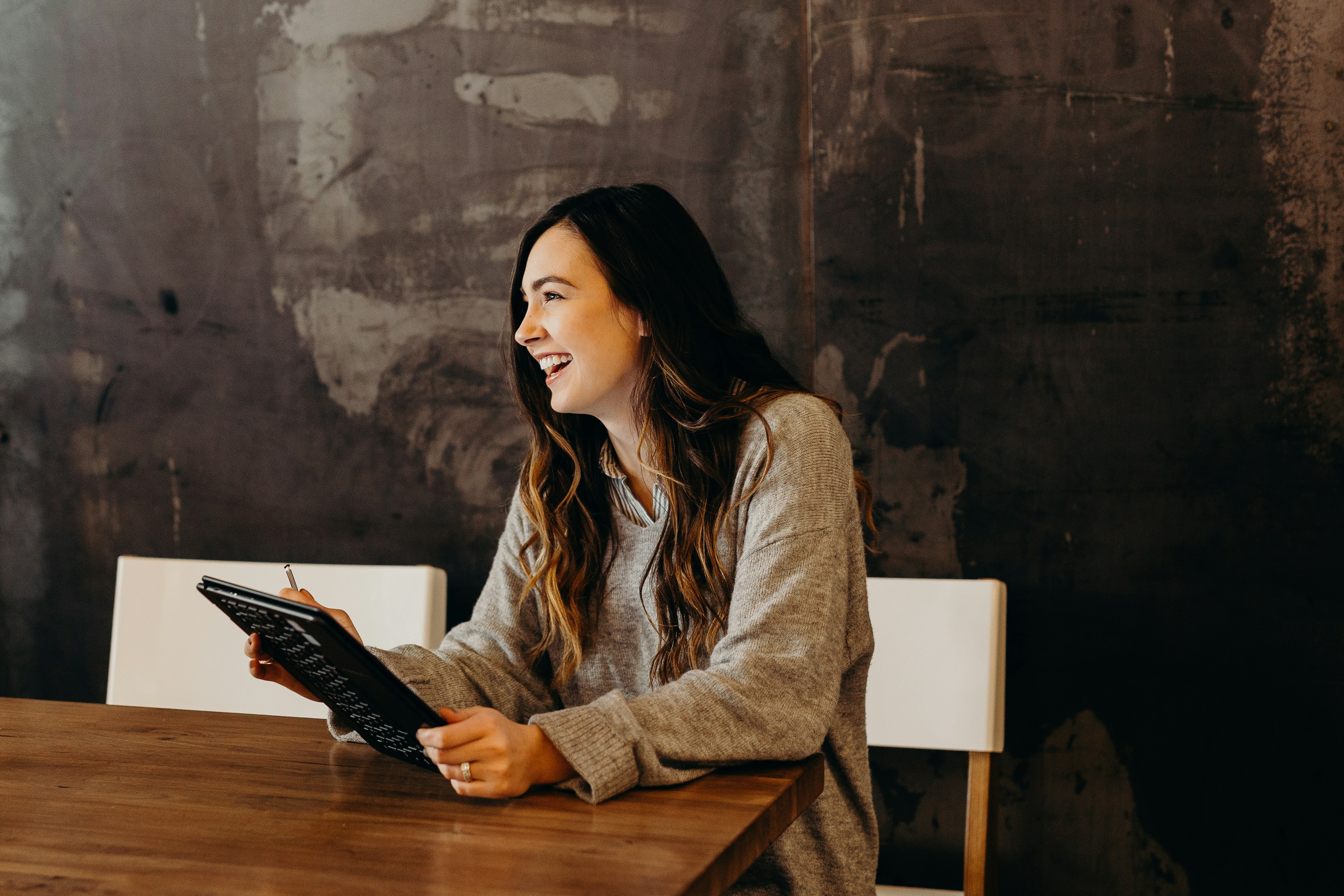 A laughing woman at workplace | Source: Unsplash