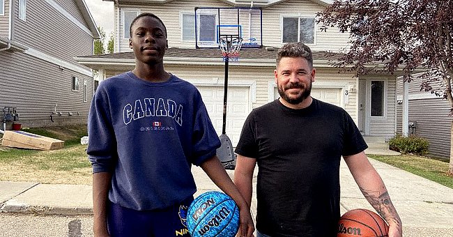 Two men posing for a photo while holding a  basketball | Photo: facebook.com/GlobalNews