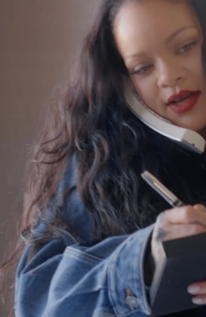 Rihanna writing something in her new video dated February 23, 2026 | Source: Instagram/badgalriri