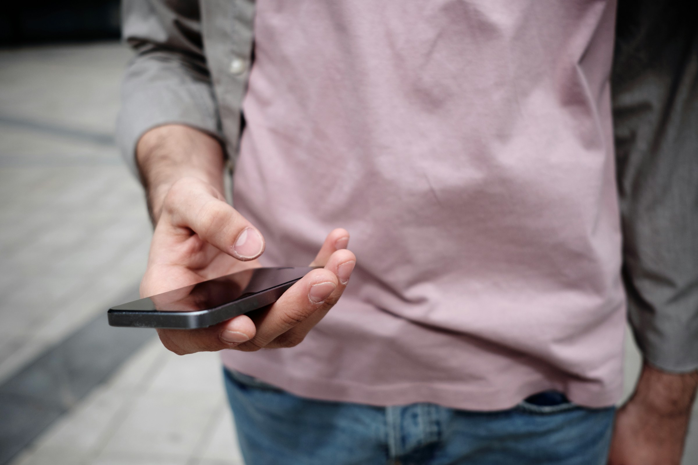 Close-up of a man holding a phone | Source: Unsplash