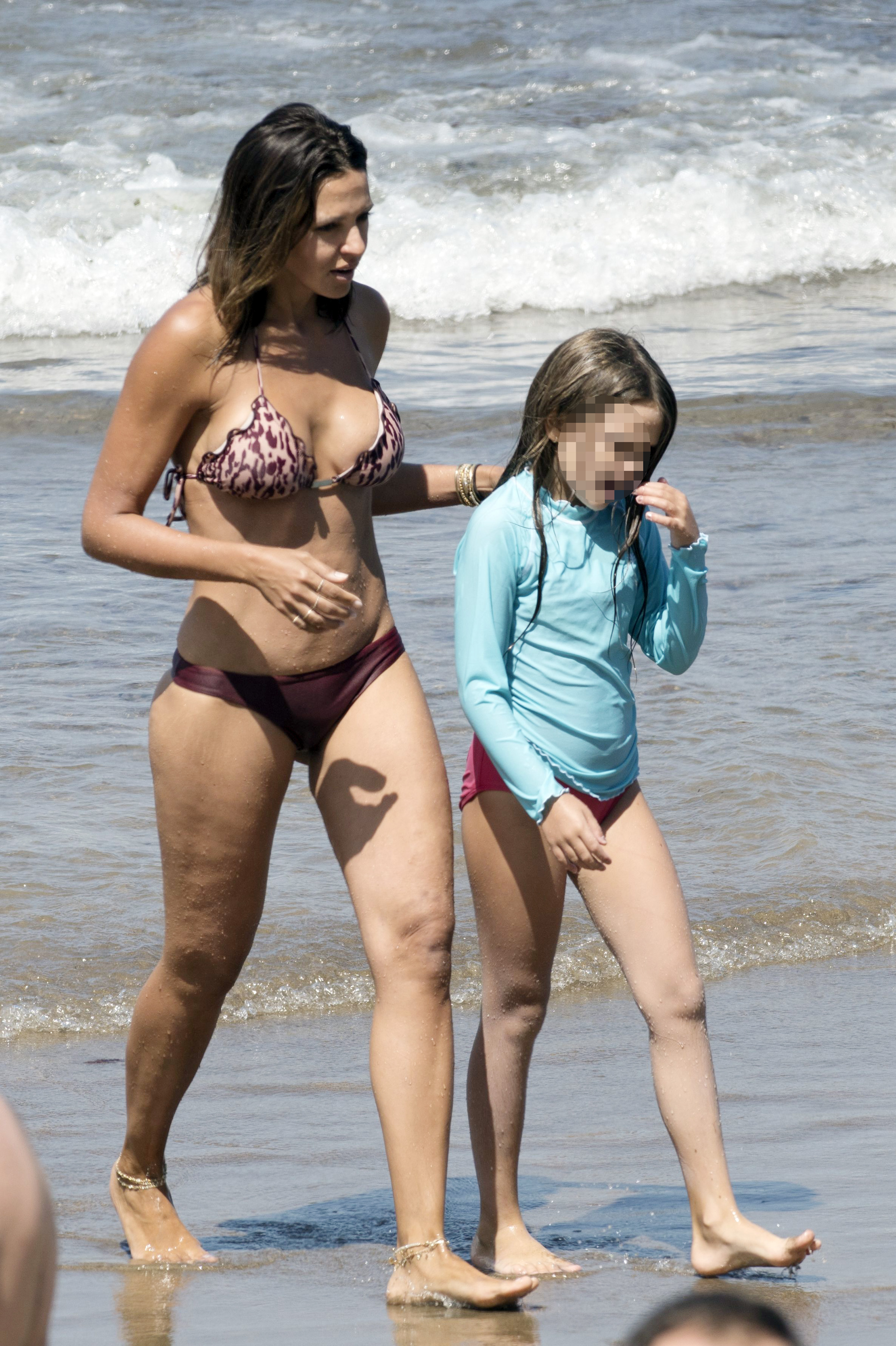 Luciana Damon shares a mother-daughter moment at the beach during a family getaway. | Source: Getty Images