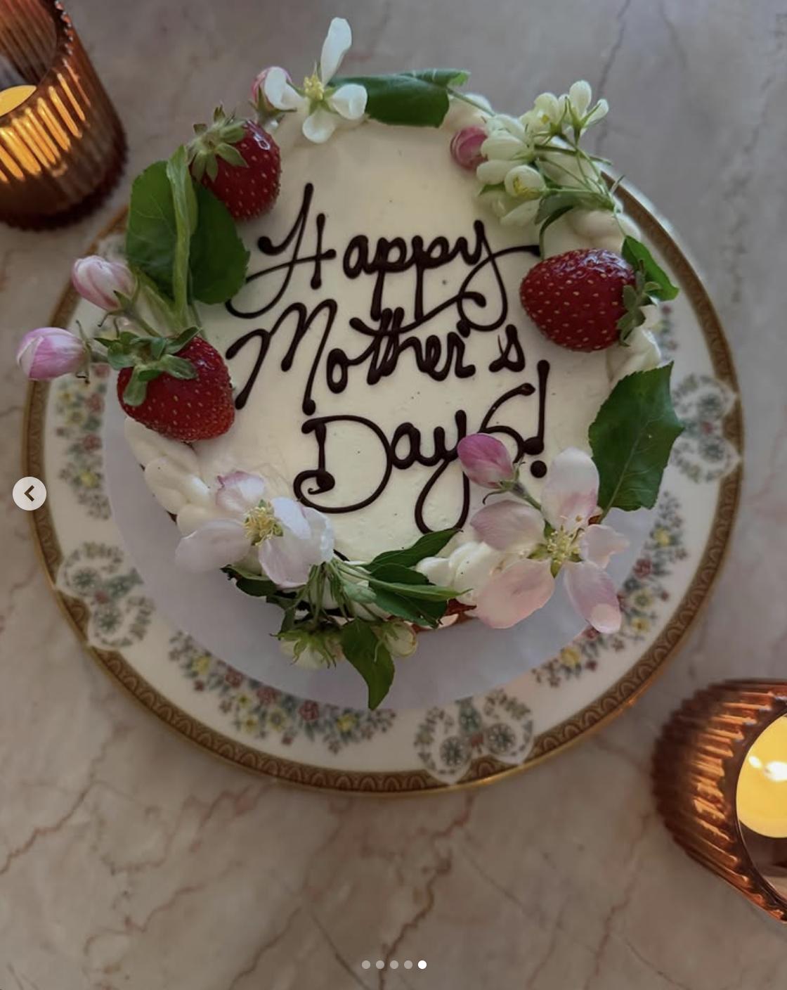 A Mother's Day cake decorated with strawberries and flowers, photographed on a dining table, posted on May 11, 2026 | Source: Instagram/haileesteinfeld