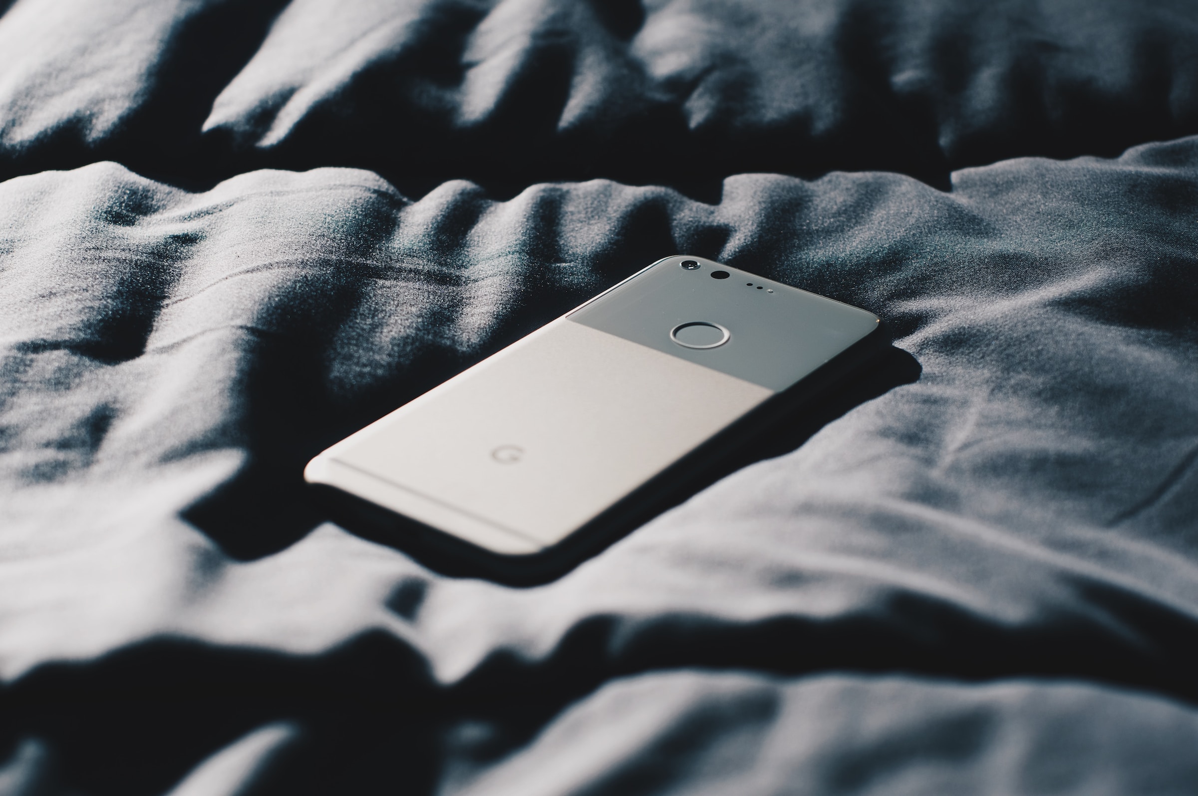 Phone on bed | Source: Pexels