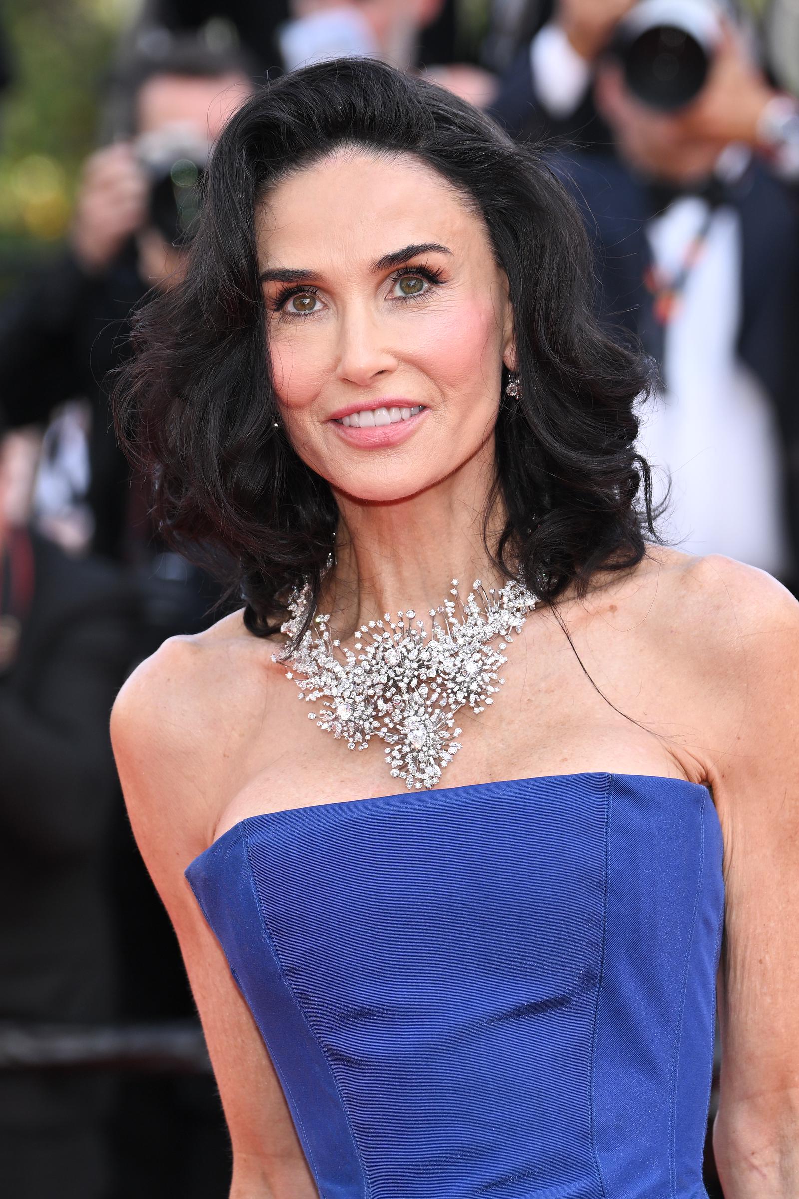 Demi Moore wears a royal-blue strapless gown paired with an oversized diamond necklace during the “La Bola Negra” screening. | Source: Getty Images