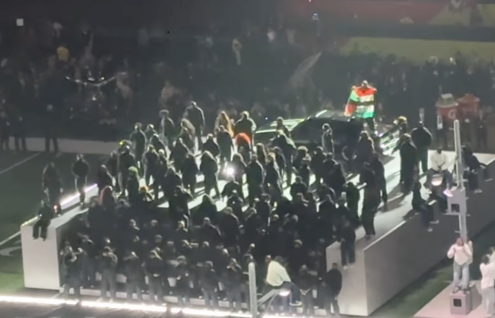 A member of the  400-member field cast is seen raising a flag in the middle of Kendrick Lamar's performance, dated February 10, 2025 | Source: Instagram/ jessekirschnbc