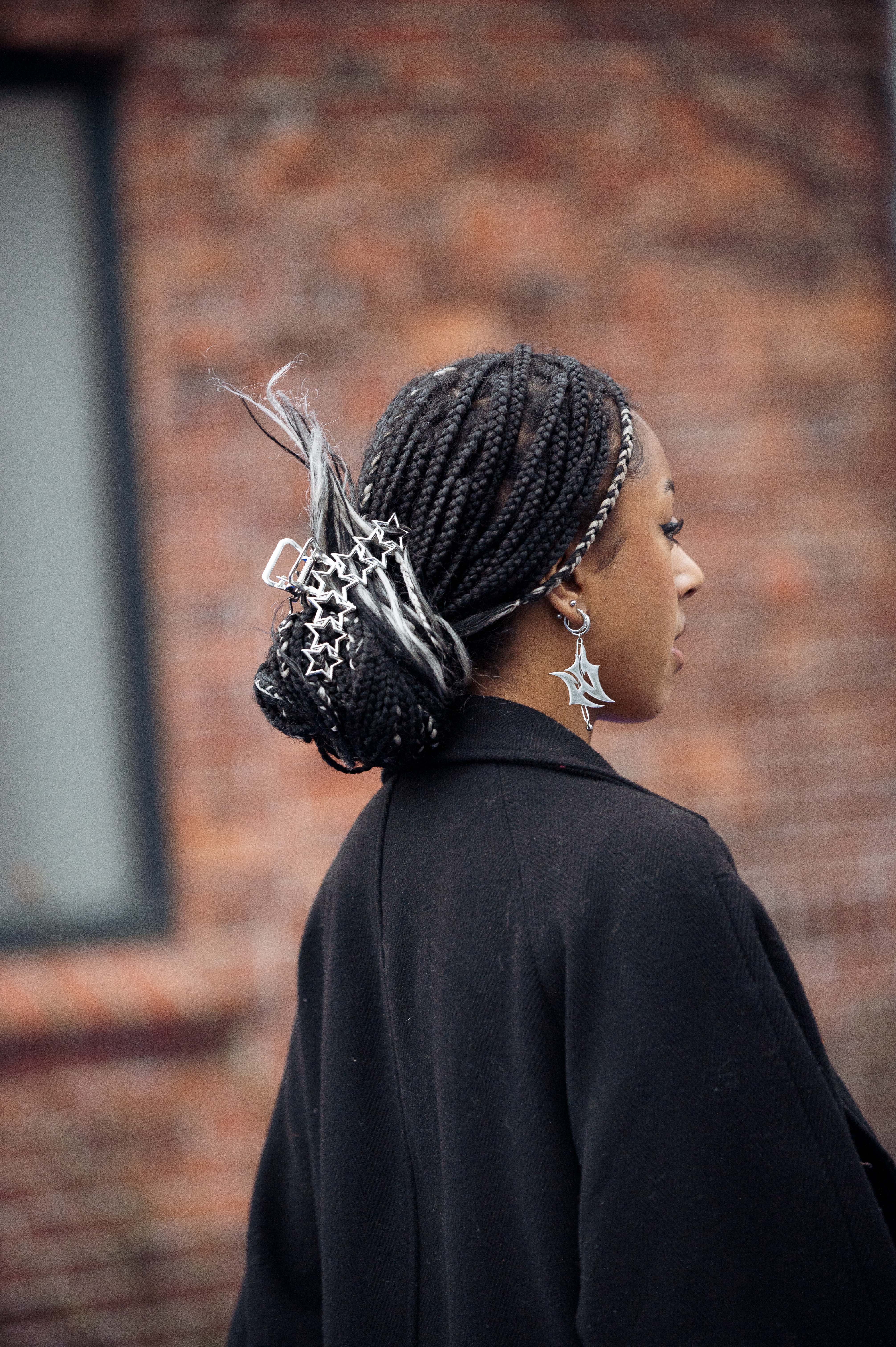 A guest wearing a black coat star shape hair accessory outside Selam Fessahaye, during the Copenhagen Fashion Week Autumn/Winter 2023 on February 01, 2023 in Copenhagen, Denmark. | Source: Getty Images