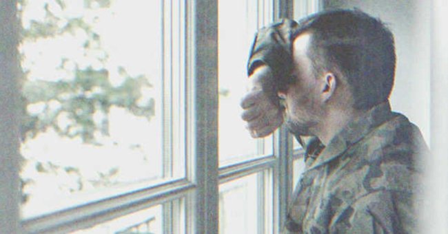 A man from the army looks out a window. | Source: Shutterstock