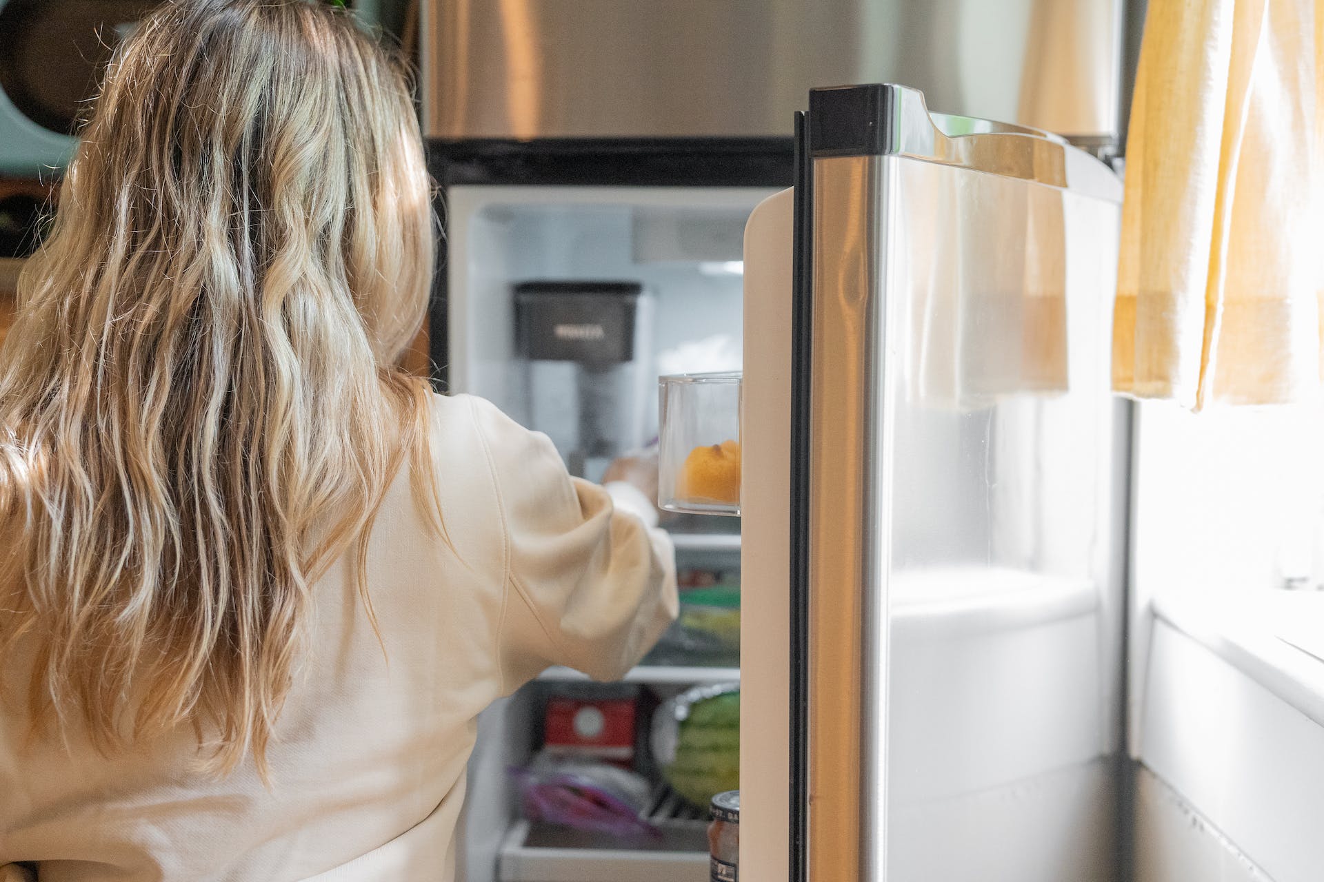 Person standing in front of fridge | Source: Pexels