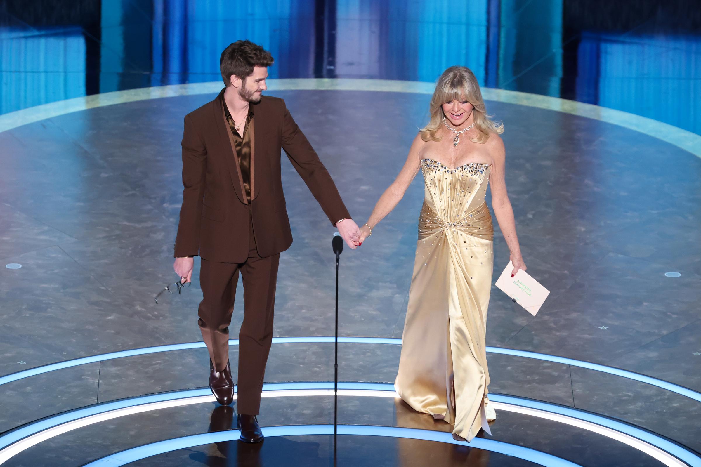 Andrew Garfield and Goldie Hawn walk toward the center of the stage at the 97th Oscars on March 2, 2025 | Source: Getty Images